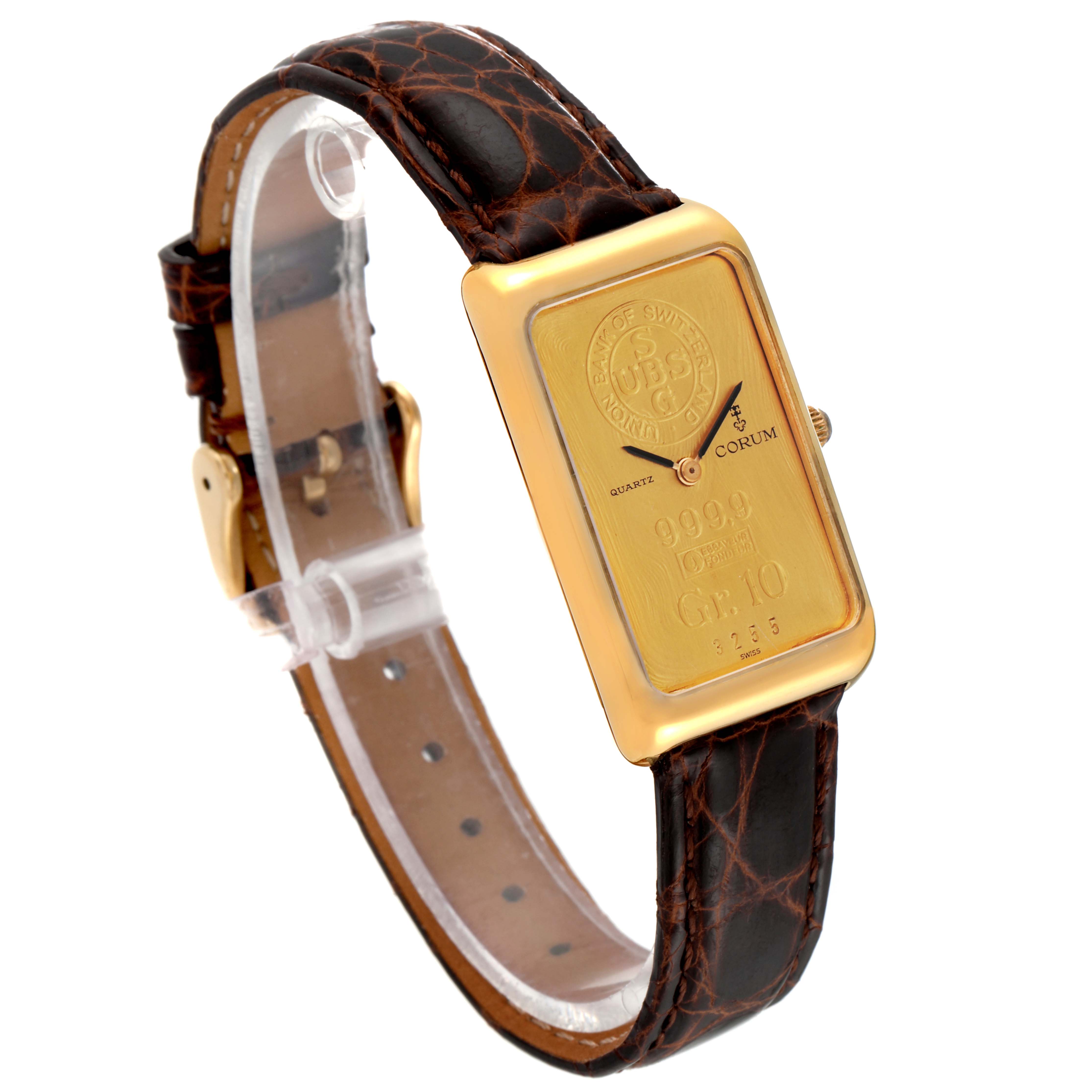 The image shows the Corum Women's Yellow Gold Champagne Dial Women's Yellow Gold Champagne Dial 18K Yellow Gold 10 Gram Ingot 999.9 Ladies Watch angled to display its face and leather strap.