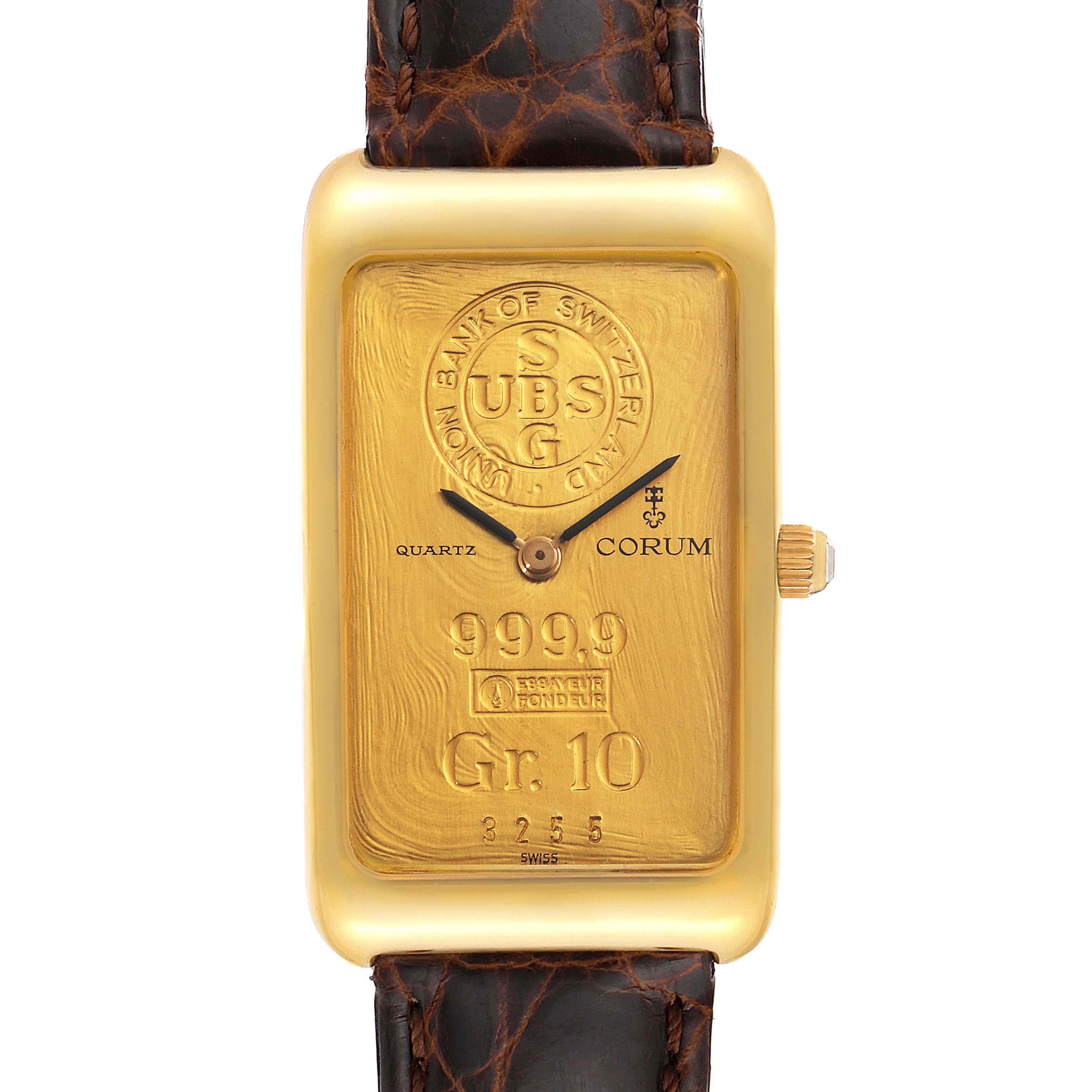 This image shows a frontal view of the Corum Women's Yellow Gold Champagne Dial Women's Yellow Gold Champagne Dial 18K Yellow Gold 10 Gram Ingot 999.9 Ladies Watch, displaying its unique ingot-style face and brown leather strap.