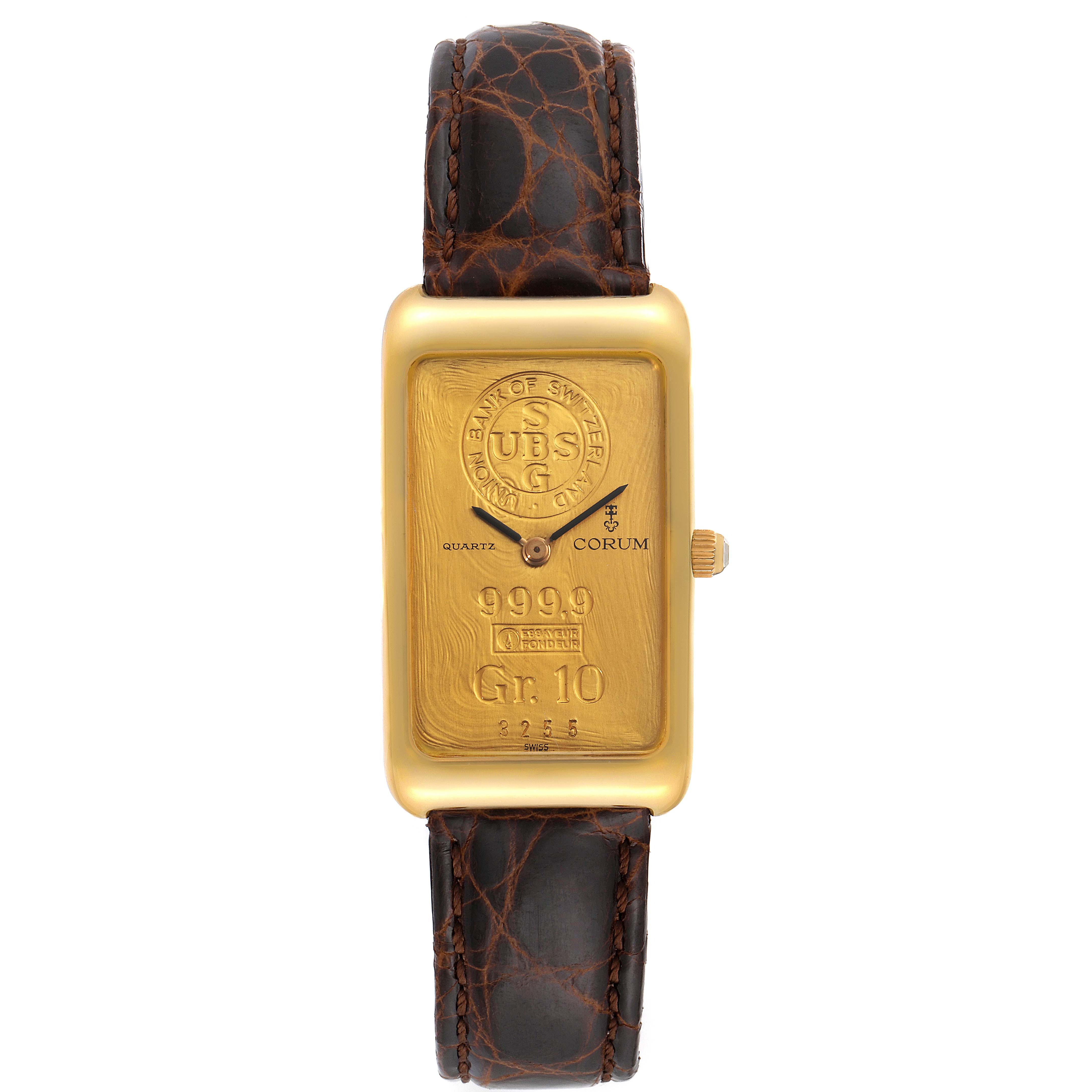 The image shows a Corum Women's Yellow Gold Champagne Dial Women's Yellow Gold Champagne Dial 18K Yellow Gold 10 Gram Ingot 999.9 Ladies Watch, displaying its face, gold ingot, and leather strap from the front angle.