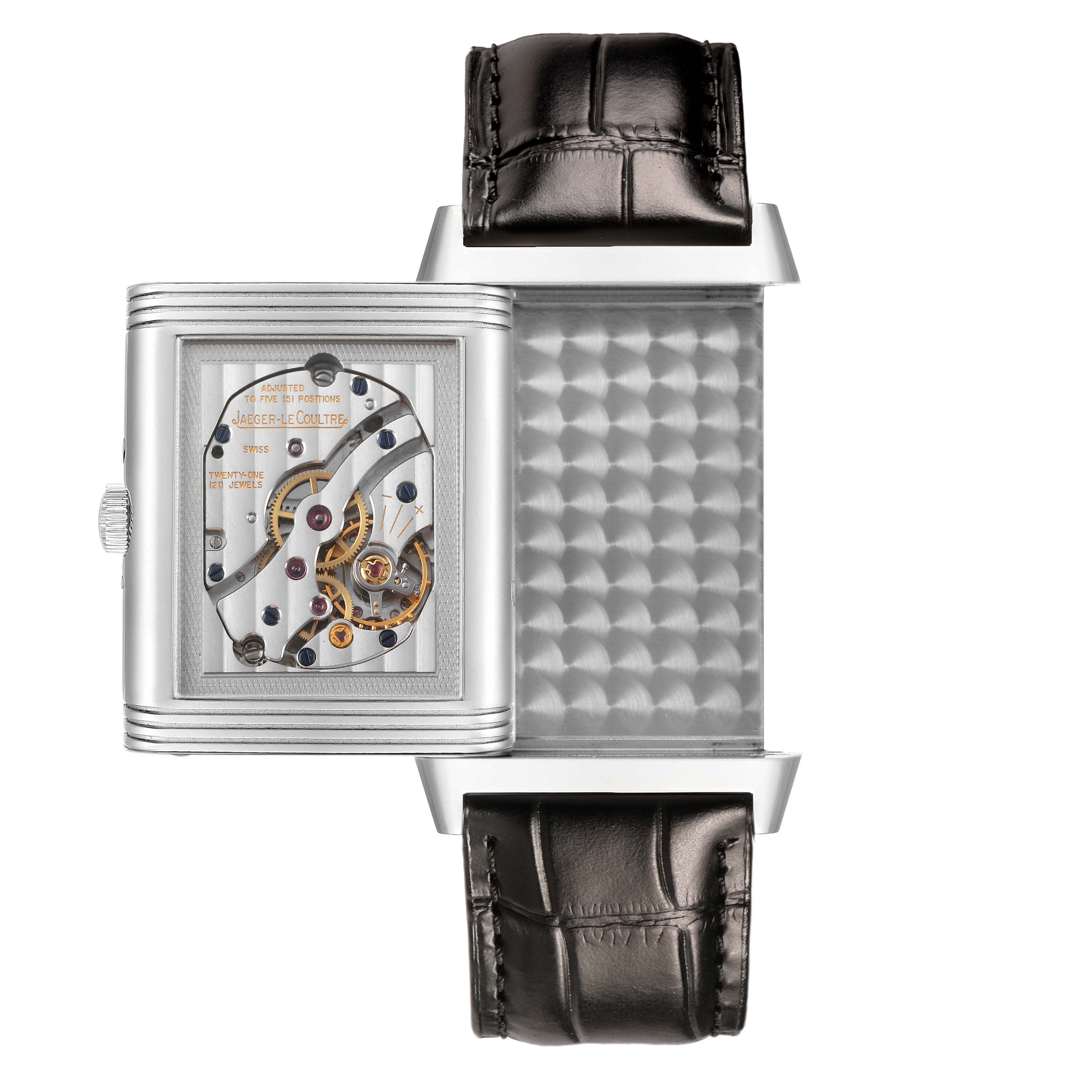 The Jaeger-LeCoultre Reverso watch is shown in a side view with its case swiveled to reveal the movement.