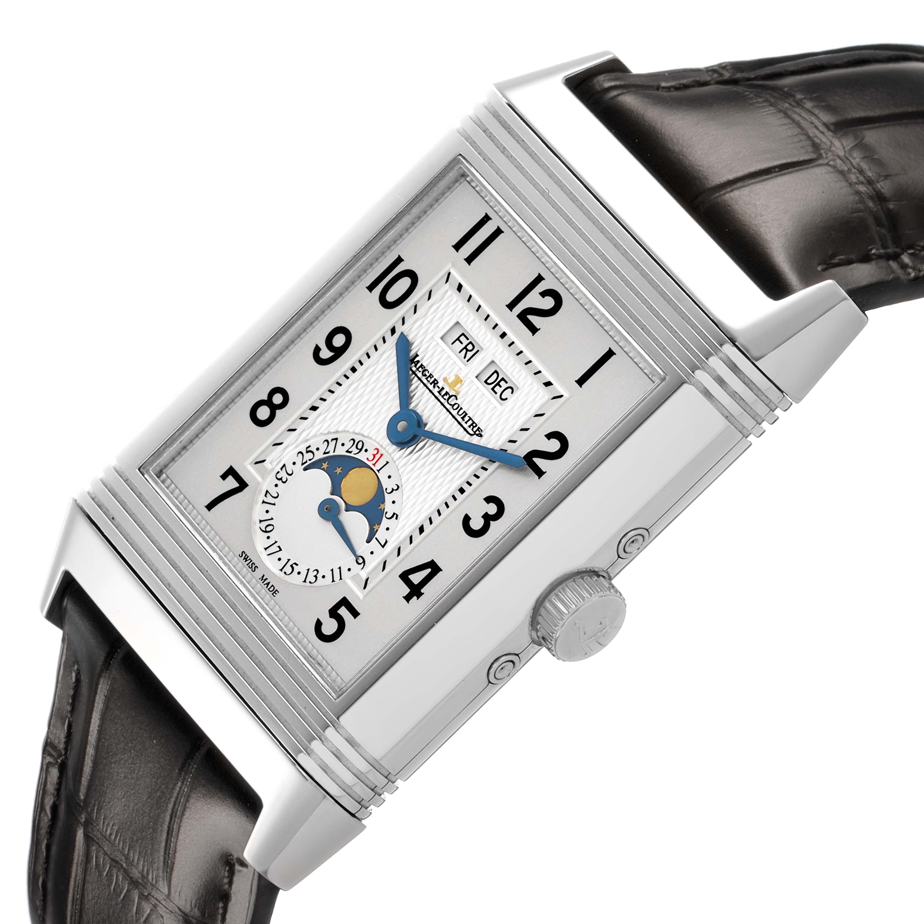 The Jaeger-LeCoultre Reverso watch is shown at an angled top view, highlighting its rectangular case, dial, crown, and leather strap.