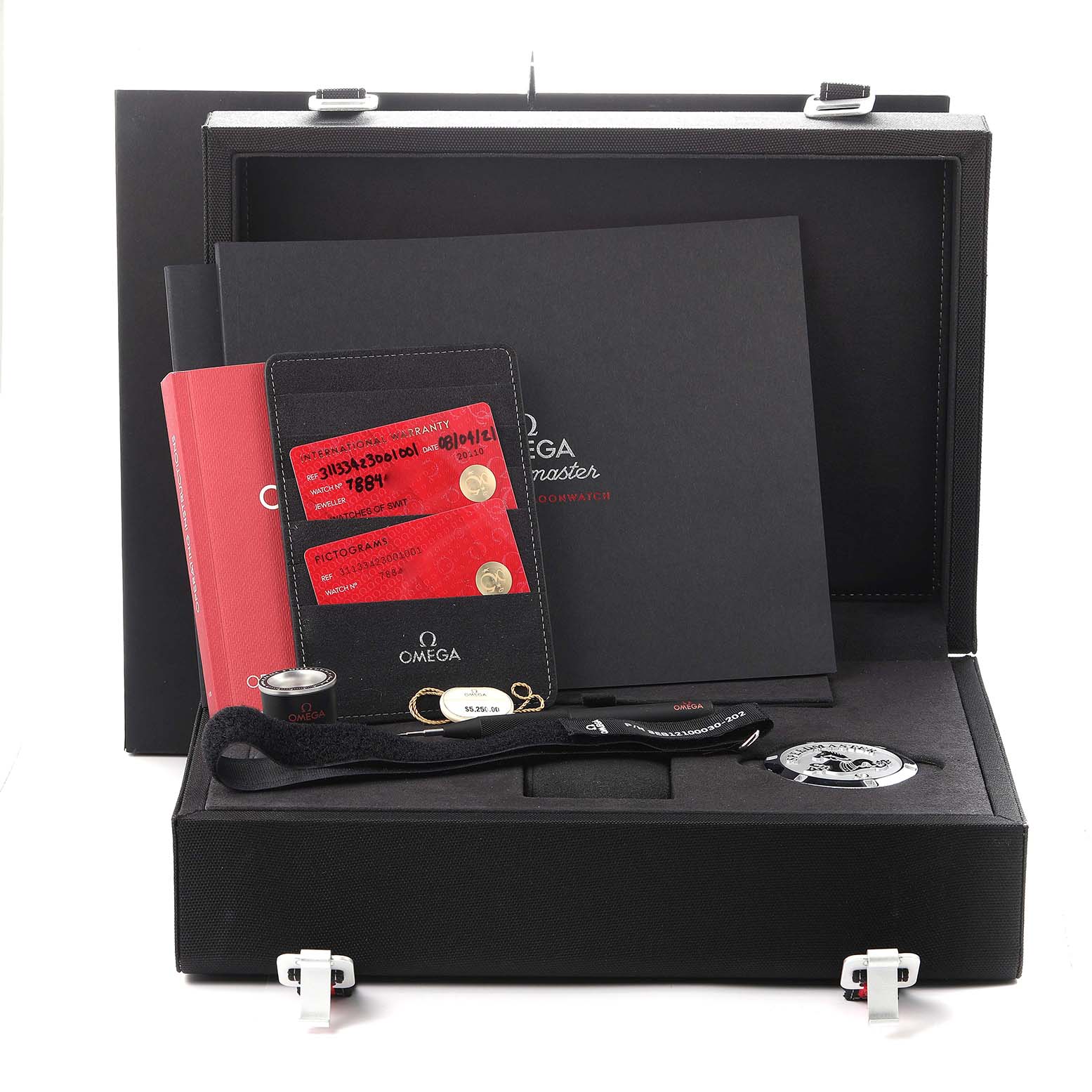 The Omega Speedmaster 311.33.42.30.01.001 Men's Stainless Steel Black Dial 311.33.42.30.01.001 Men's Stainless Steel Black Dial set includes documents, warranty cards, a magnifying tool, and a medallion in an open black case.