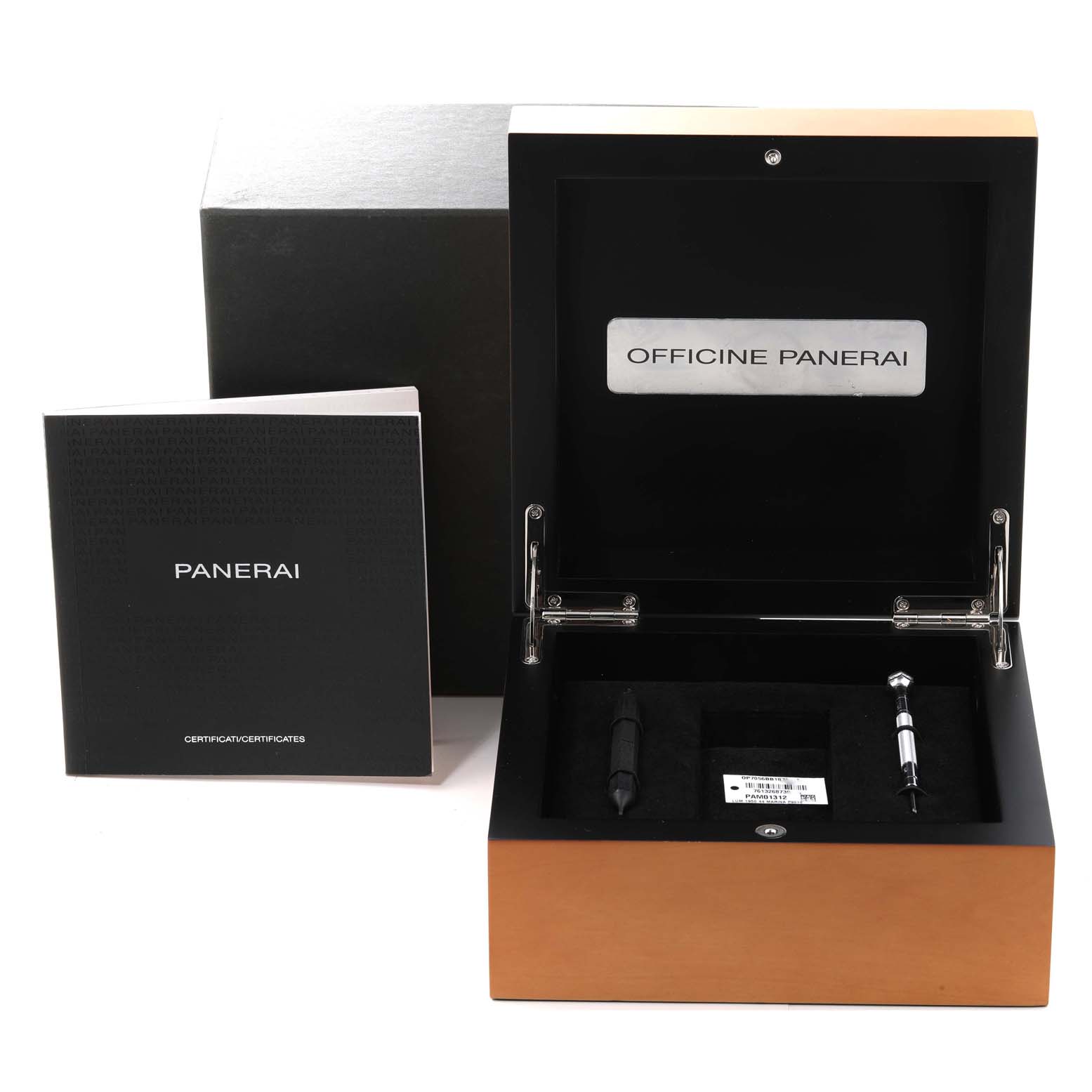 The image shows an open box with "Officine Panerai" branding, containing tools and papers for the Luminor model by Panerai.