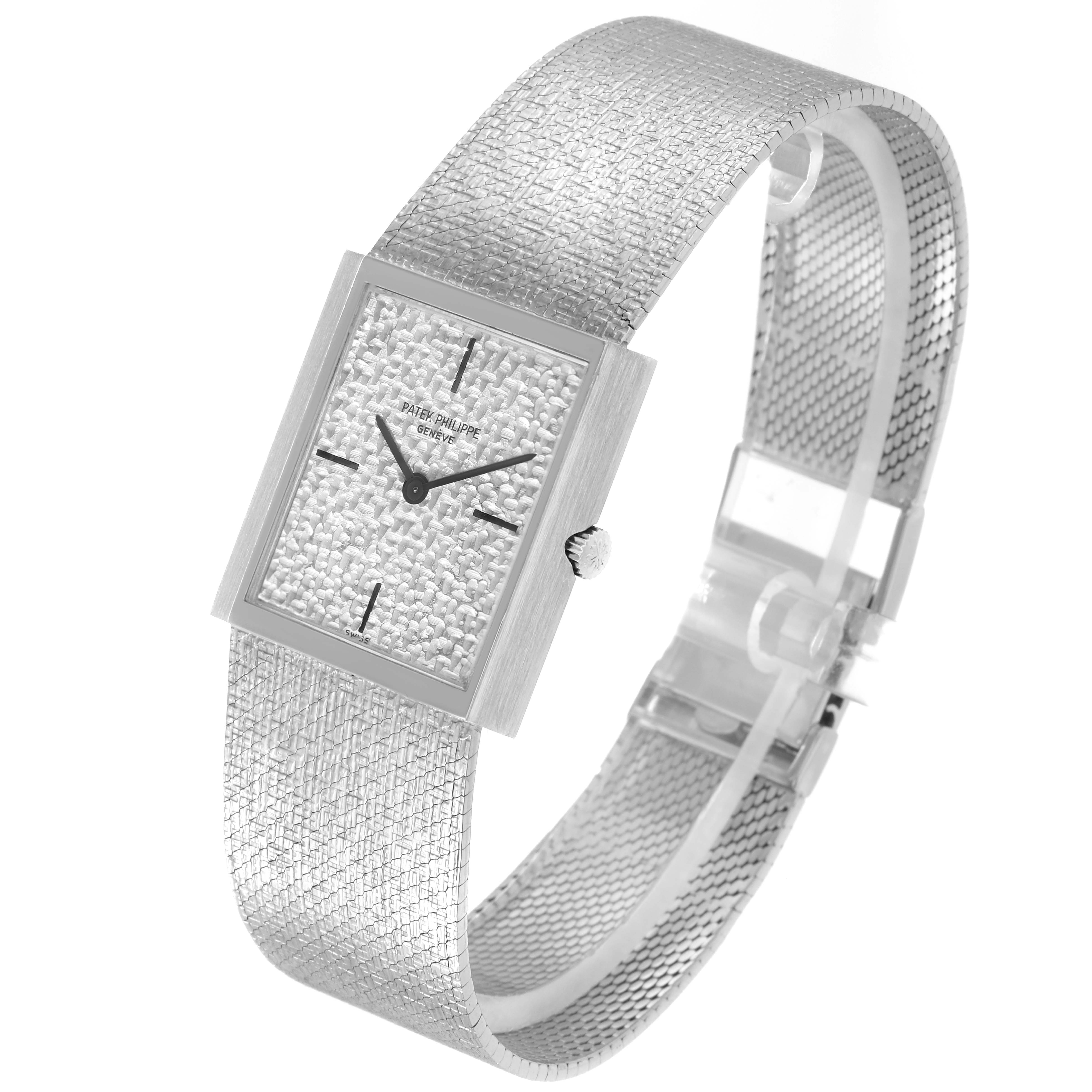 The Patek Philippe Vintage 3491/3 Women
s White Gold Silver Dial 3491/3 Women
s White Gold Silver Dial model is shown from a side angle highlighting its textured dial, rectangular case, and mesh bracelet.