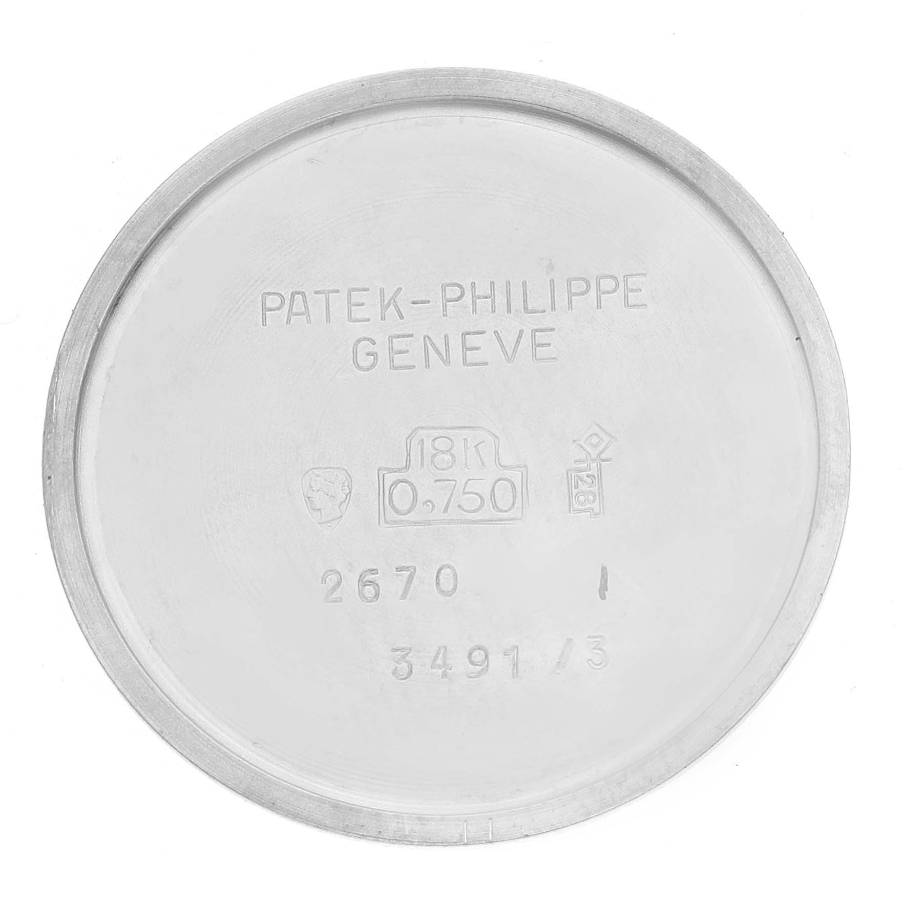 The image shows the inside case back of a vintage Patek Philippe watch with engravings.