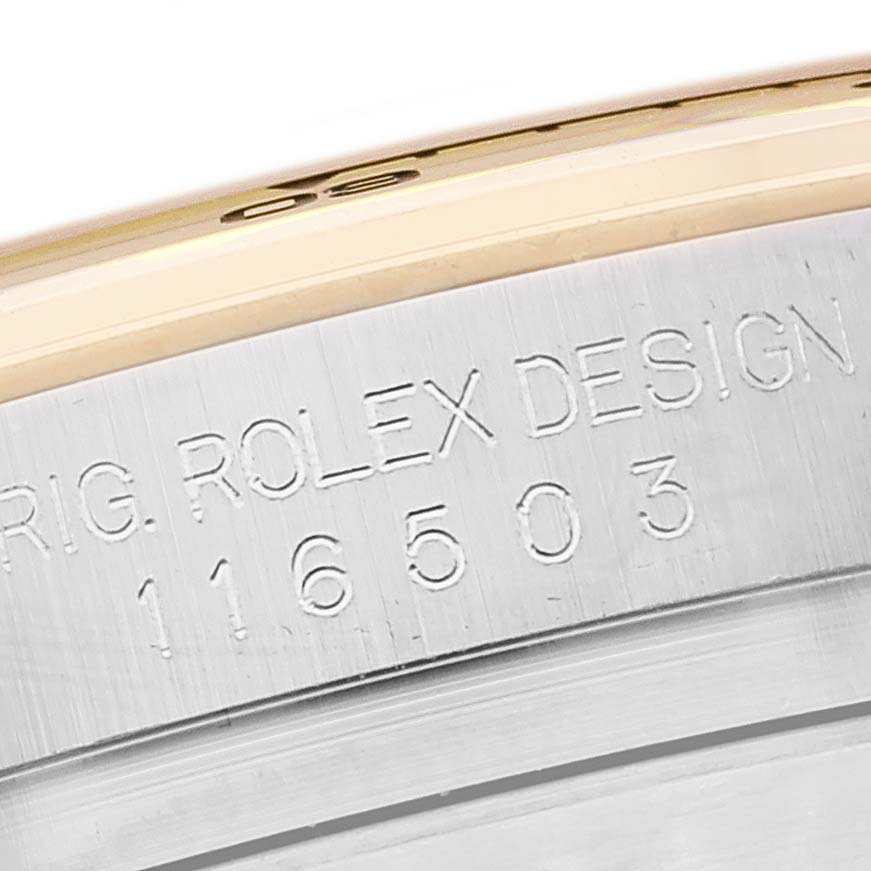 The image shows a close-up of the serial number and "ROLEX DESIGN" engraving on the case of a Rolex Daytona 116503 Men
s Steel and Gold (two tone) Black Dial 116503 Men
s Steel and Gold (two tone) Black Dial watch.