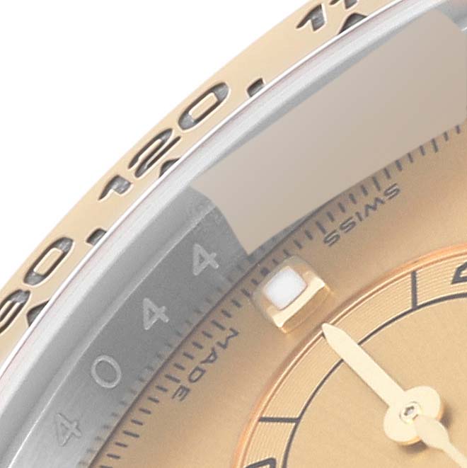 The close-up angle shows the bezel, part of the dial, and the hour hand of the Rolex Daytona 116503 Men's Steel and Gold (two tone) Champagne Dial 116503 Men's Steel and Gold (two tone) Champagne Dial watch.