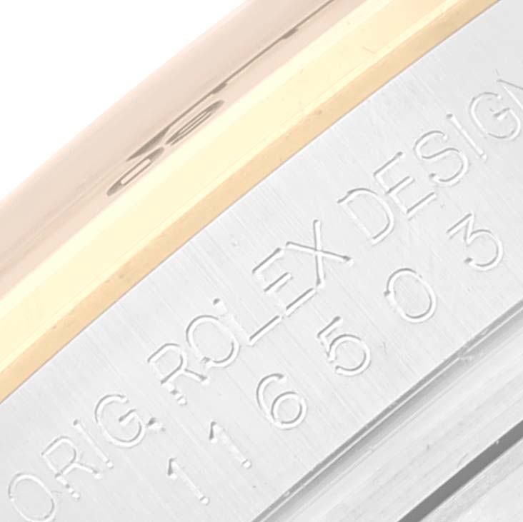 The image shows an angled view of the side of a Rolex Daytona 116503 Men's Steel and Gold (two tone) Champagne Dial 116503 Men's Steel and Gold (two tone) Champagne Dial watch case, specifically highlighting the engraved serial number and text.