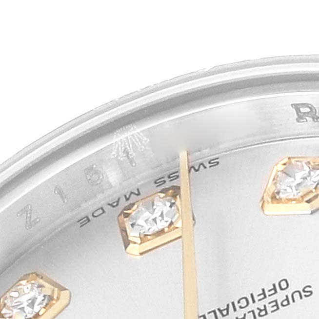 The image shows a close-up of the dial and part of the bezel of a Rolex Datejust 179173 Women's Steel and Gold (two tone) Silver Dial 179173 Women's Steel and Gold (two tone) Silver Dial watch, highlighting diamond hour markers.