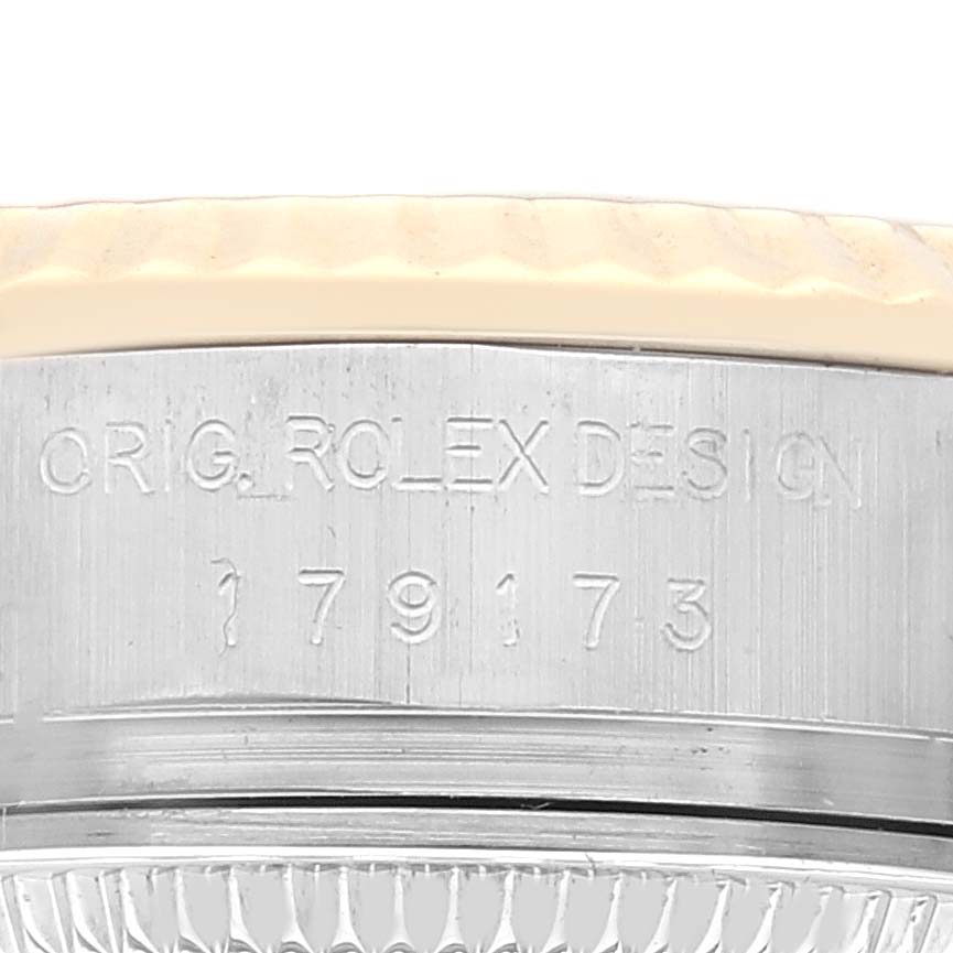 This close-up image shows the side engraving of the case on a Rolex Datejust 179173 Women's Steel and Gold (two tone) Silver Dial 179173 Women's Steel and Gold (two tone) Silver Dial model.