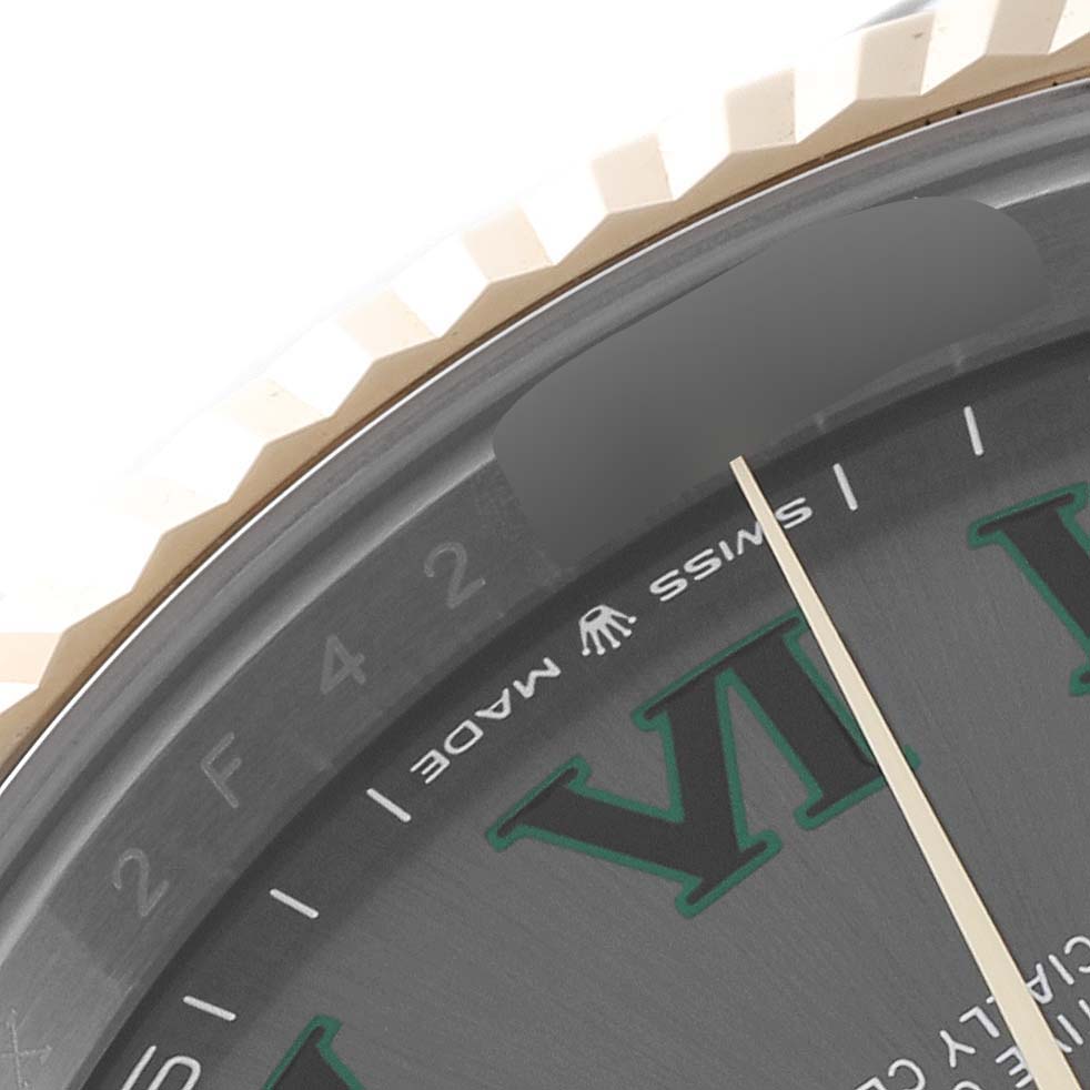 The image shows a close-up of the Rolex Datejust 41 126333 Men
s Steel and Gold (two tone) Grey Dial 126333 Men
s Steel and Gold (two tone) Grey Dial bezel and part of the dial with Roman numerals.