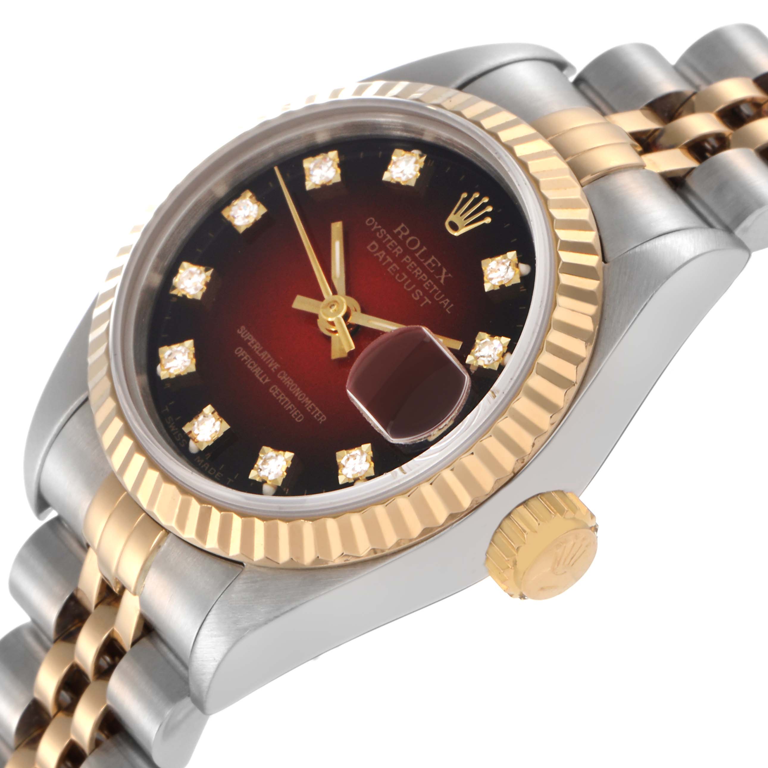 The Rolex Datejust 69173 Women
s Steel and Gold (two tone) Red Dial 69173 Women
s Steel and Gold (two tone) Red Dial watch is shown from a three-quarter angle, highlighting its dial, fluted bezel, crown, and bracelet.