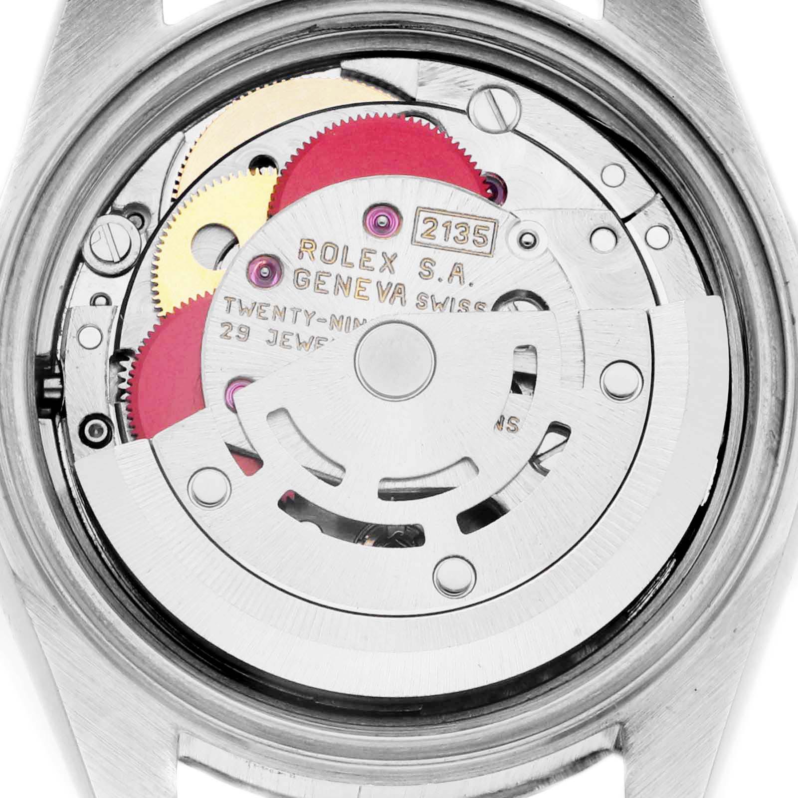 The image shows the movement of a Rolex Datejust 69174 Women
s Stainless Steel Silver Dial 69174 Women
s Stainless Steel Silver Dial watch from a top-down angle, focusing on its internal components and gears.
