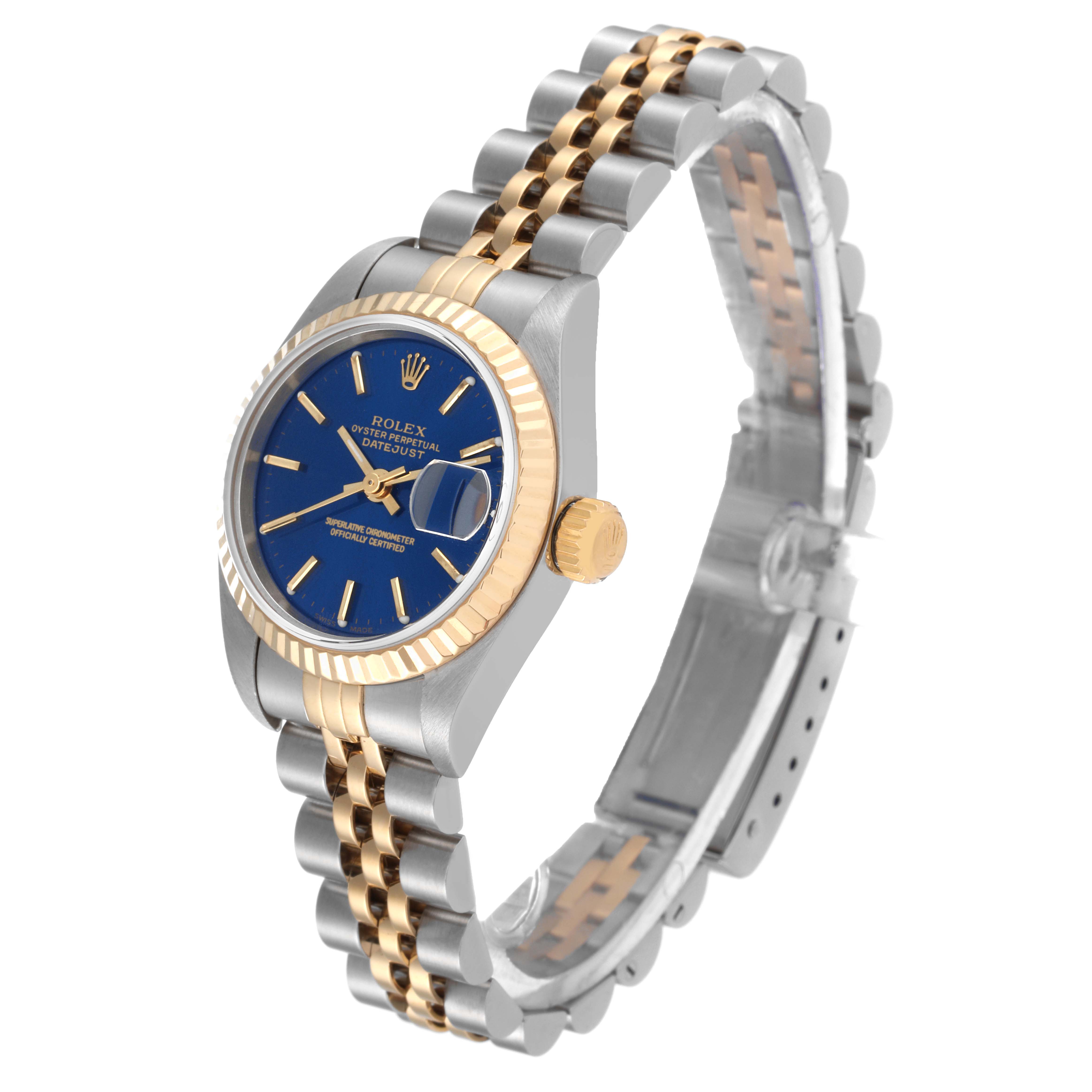 The image shows the Rolex Datejust 79173 Women's Steel and Gold (two tone) Blue Dial 79173 Women's Steel and Gold (two tone) Blue Dial watch from a three-quarter angle, highlighting its blue dial, fluted bezel, crown, and two-tone bracelet.