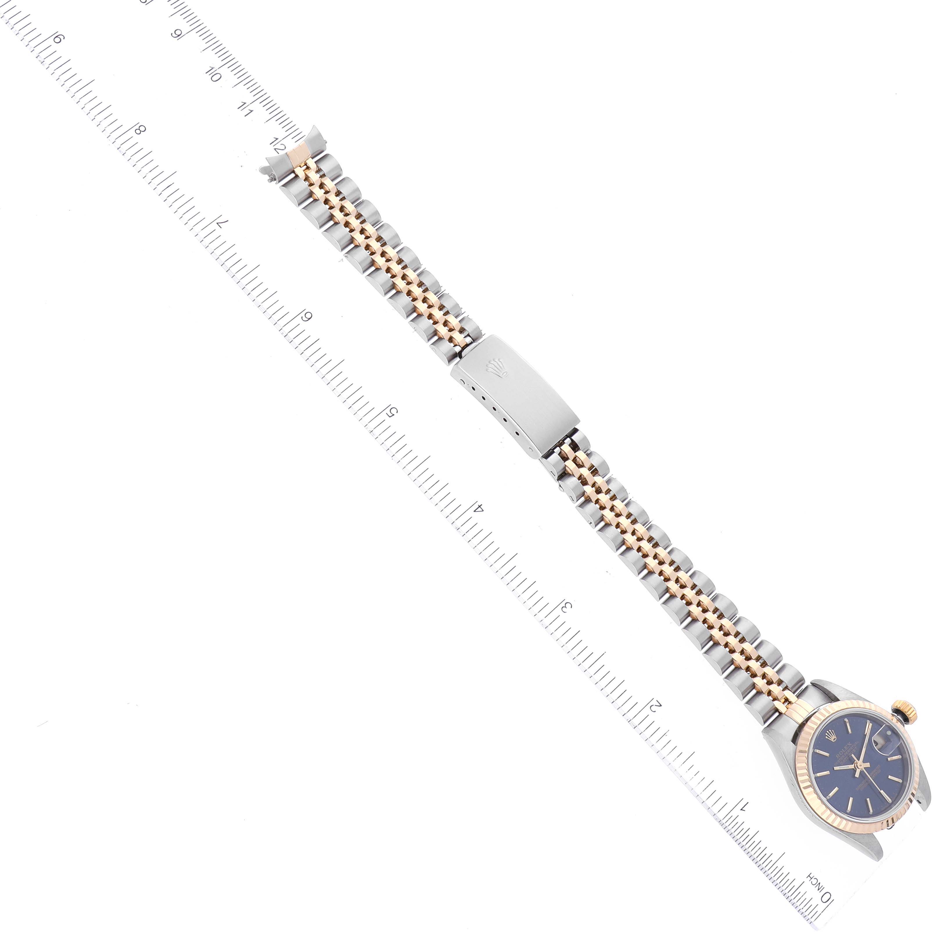 This image shows a Rolex Datejust 79173 Women's Steel and Gold (two tone) Blue Dial 79173 Women's Steel and Gold (two tone) Blue Dial watch laid flat with its face and partially extended two-tone bracelet.