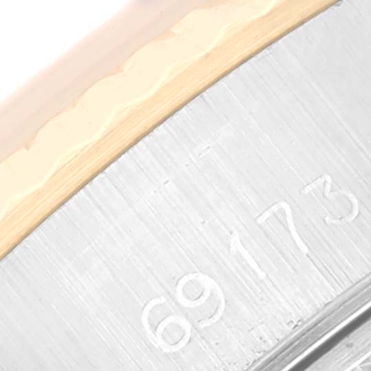 This is a close-up image showing the serial number and edge of the bezel of a Rolex Datejust 69173 Women's Steel and Gold (two tone) Champagne Dial 69173 Women's Steel and Gold (two tone) Champagne Dial watch.