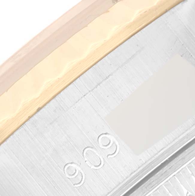 This close-up image shows the outer edge of the bezel and part of the casing with engravings of a Rolex Datejust 69173 Women's Steel and Gold (two tone) Champagne Dial 69173 Women's Steel and Gold (two tone) Champagne Dial watch.