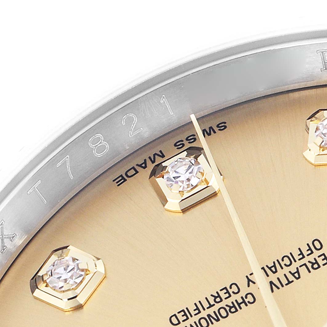 The image shows a close-up of the Rolex Datejust 116233 Men
s Steel and Gold (two tone) Champagne Dial 116233 Men
s Steel and Gold (two tone) Champagne Dial watch dial, highlighting diamond markers, text, and part of the rehaut.
