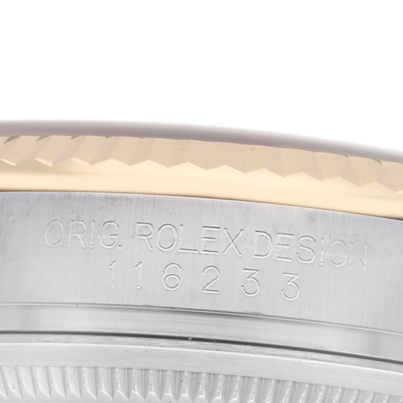 The image shows a close-up of the engraved side of a Rolex Datejust 116233 Men
s Steel and Gold (two tone) Champagne Dial 116233 Men
s Steel and Gold (two tone) Champagne Dial watch case, displaying the model number.
