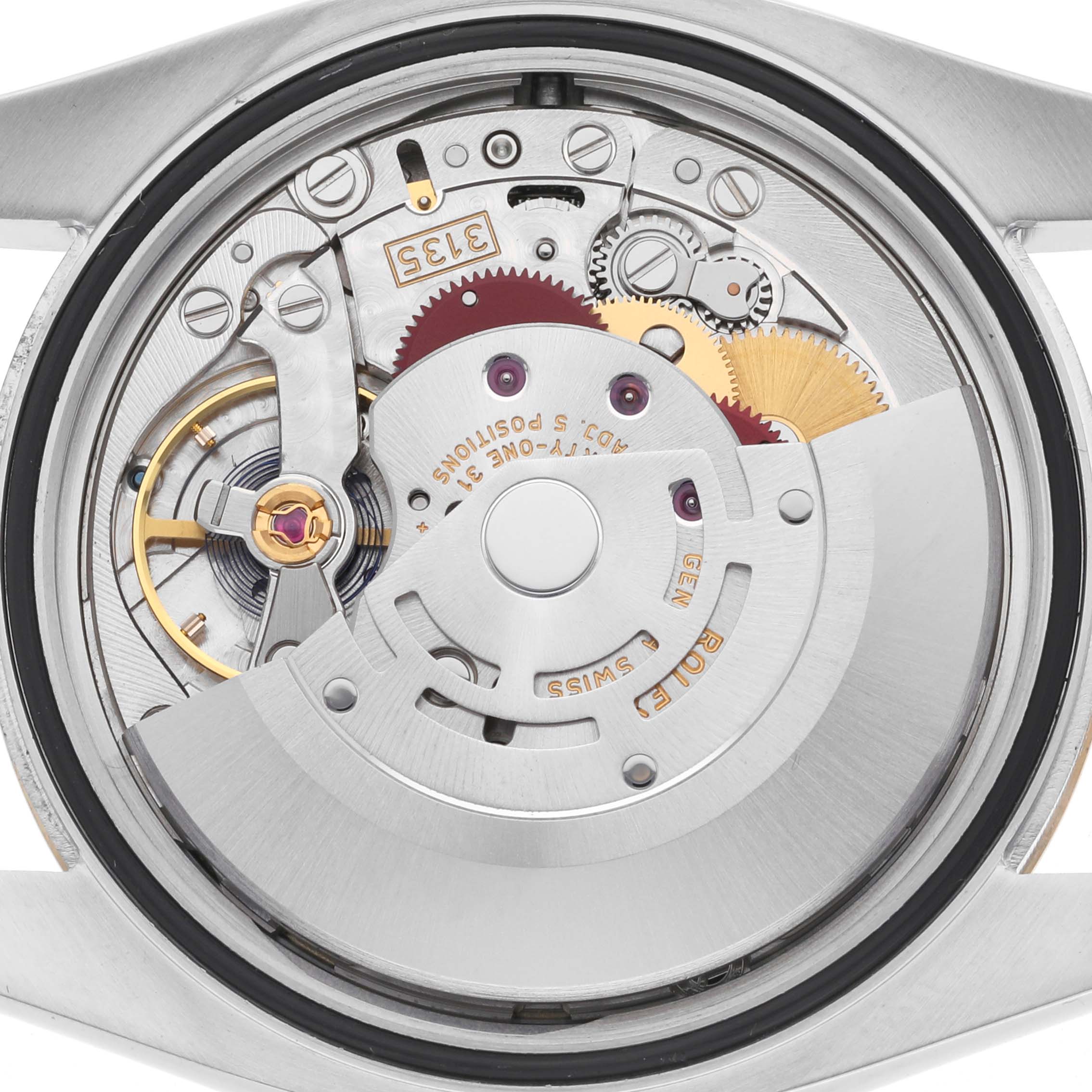 The image shows the Rolex Datejust 116233 Men
s Steel and Gold (two tone) Champagne Dial 116233 Men
s Steel and Gold (two tone) Champagne Dial watch movement from the back, highlighting gears, the rotor, and intricate mechanical components.