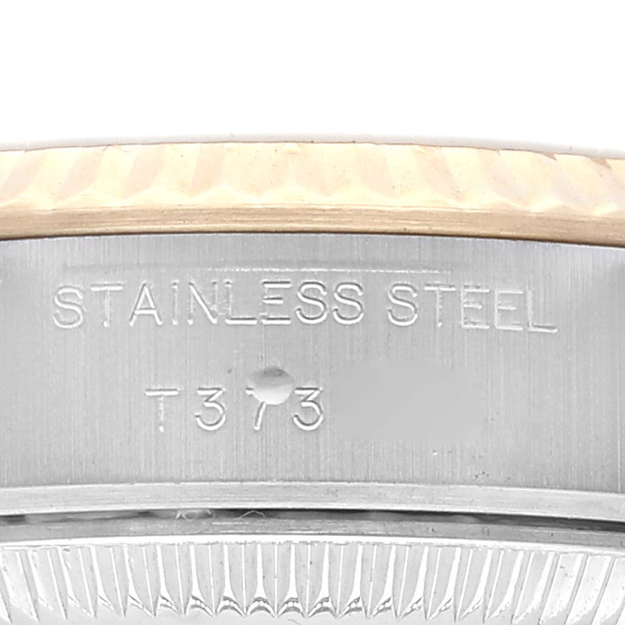 The image shows a close-up of the stainless steel side of a Rolex Datejust 69173 Women's Steel and Gold (two tone) Champagne Dial 69173 Women's Steel and Gold (two tone) Champagne Dial watch with engravings.