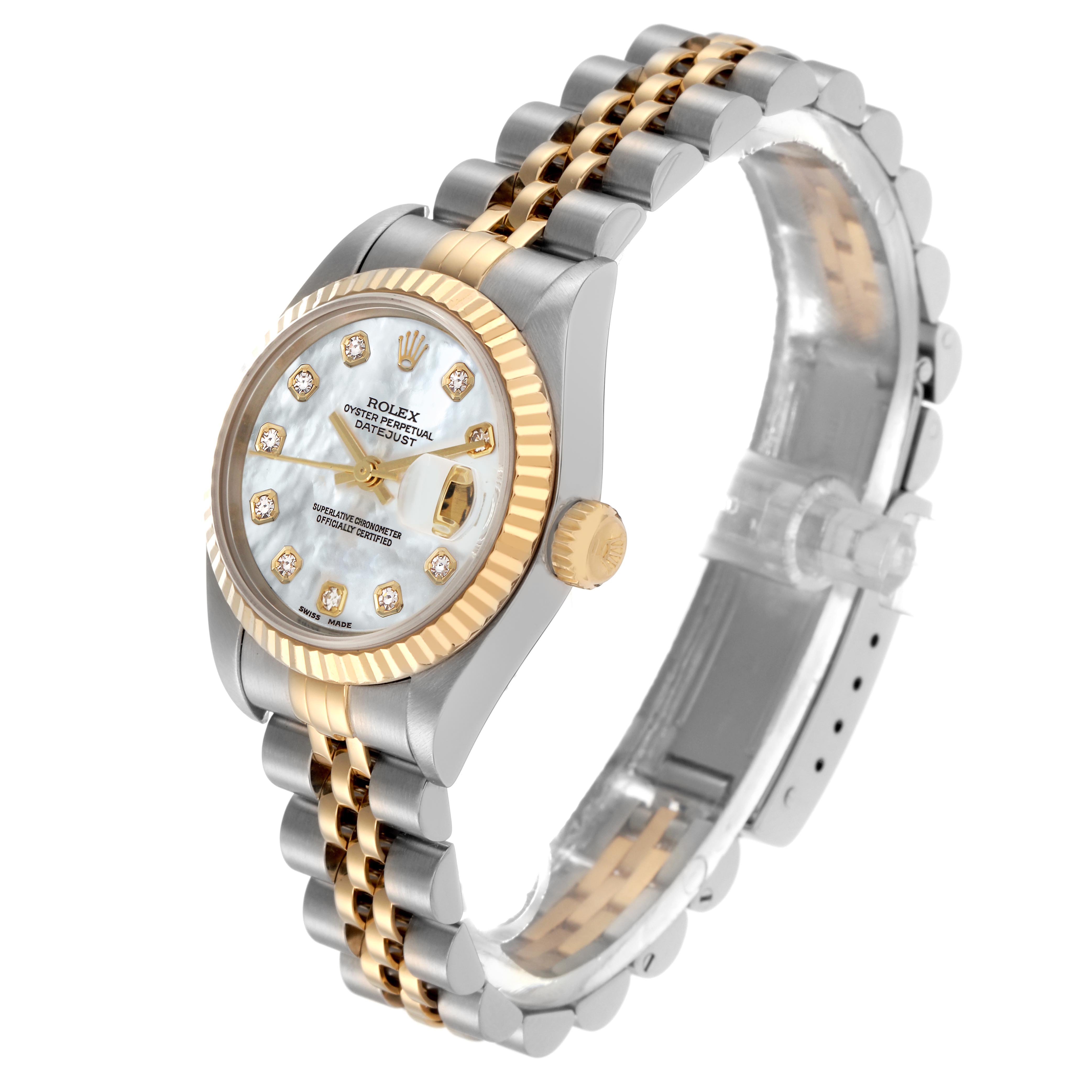 The Rolex Datejust 79173 Women
s Steel and Gold (two tone) Mother of Pearl Dial 79173 Women
s Steel and Gold (two tone) Mother of Pearl Dial is shown from a slight side angle, highlighting the face, two-tone bracelet, fluted bezel, and crown.