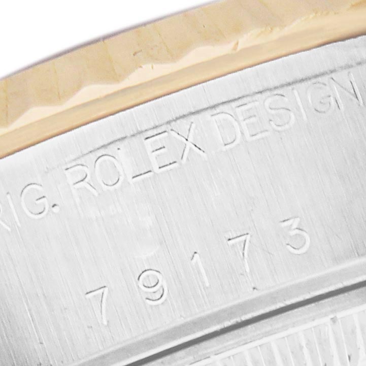 The image shows a close-up of the engraved case side of a Rolex Datejust 79173 Women
s Steel and Gold (two tone) Mother of Pearl Dial 79173 Women
s Steel and Gold (two tone) Mother of Pearl Dial, displaying the model number and design details.