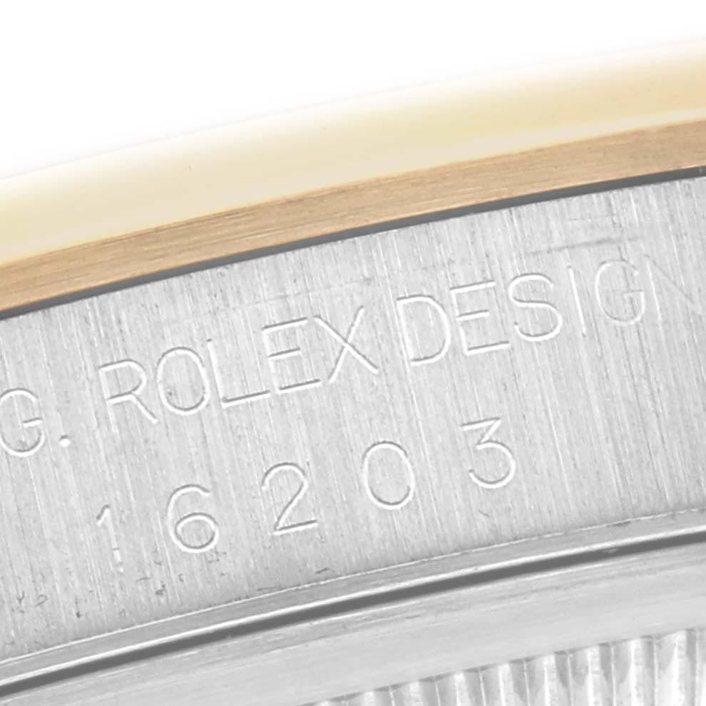 The image shows a close-up of the side of a Rolex Datejust 16203 Men
s Steel and Gold (two tone) Grey Dial 16203 Men
s Steel and Gold (two tone) Grey Dial, focusing on the model number engraving.