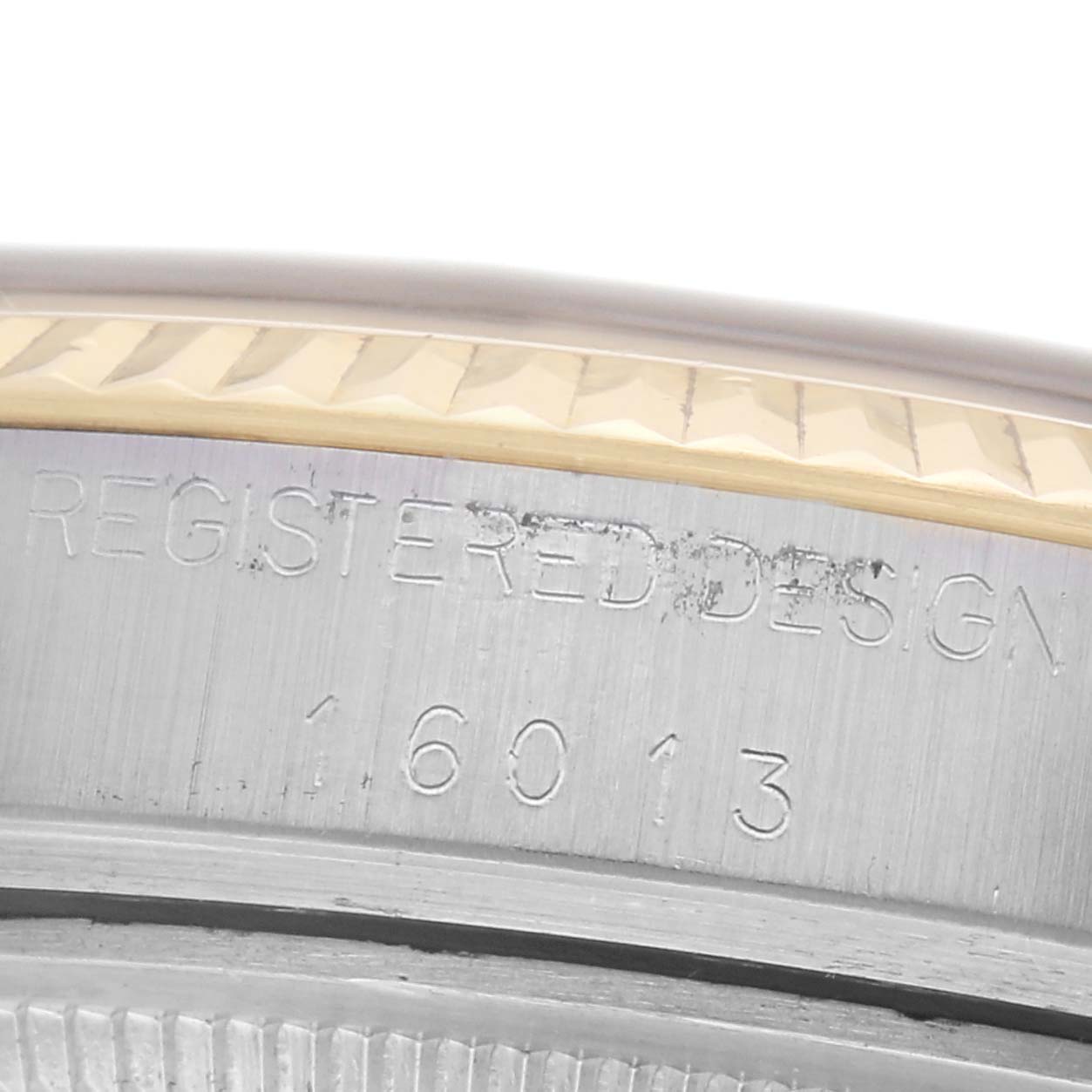 The image shows a close-up of the Rolex Datejust 16013 Men
s Steel and Gold (two tone) Champagne Dial 16013 Men
s Steel and Gold (two tone) Champagne Dial
s side, featuring an engraved number and part of the bezel.