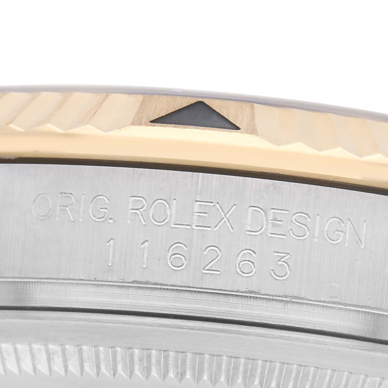 The image shows the side view of a Rolex Turn-o-Graph 116263 Men
s Steel and Gold (two tone) White Dial 116263 Men
s Steel and Gold (two tone) White Dial model bezel, highlighting engraved text and a triangular marker.