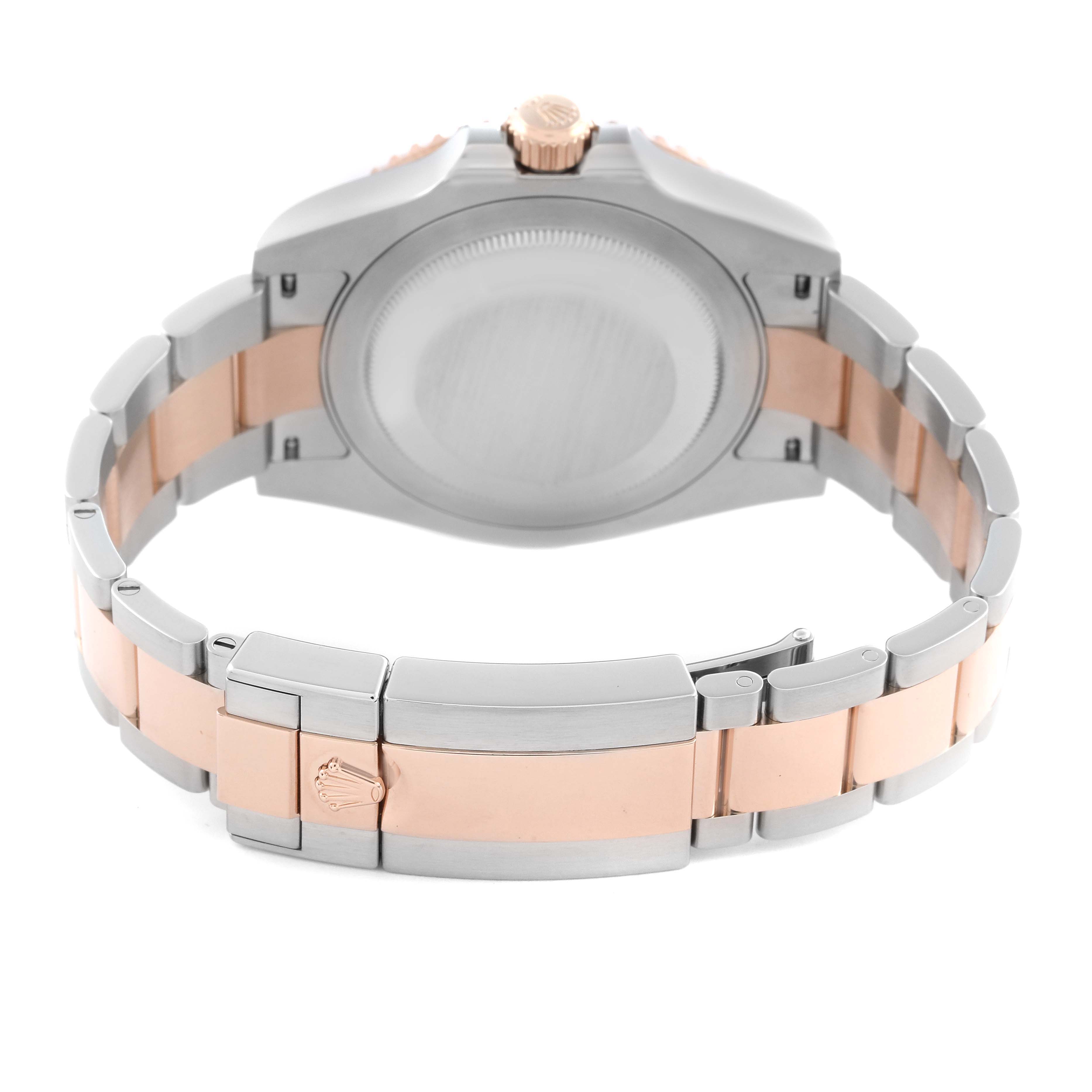 The Rolex GMT-Master 126711 Men
s Steel and Gold (two tone) Black Dial 126711 Men
s Steel and Gold (two tone) Black Dial watch is shown from the back, highlighting the case back, crown, and two-tone bracelet with a clasp.