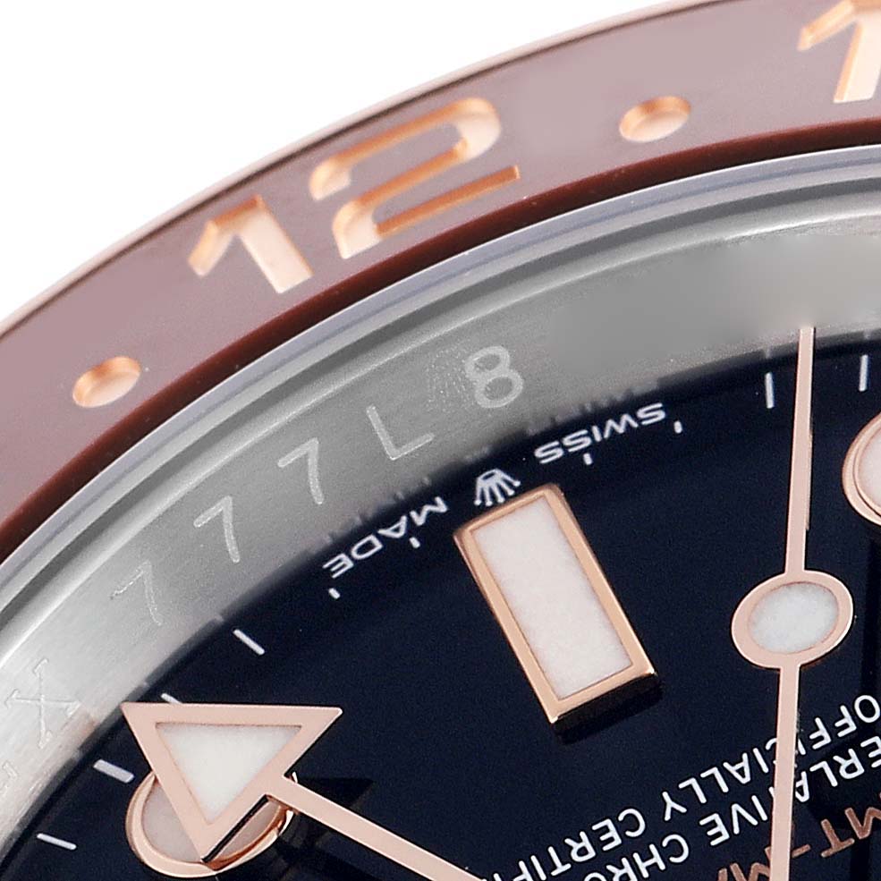 The image shows a close-up of the dial and bezel of a Rolex GMT-Master 126711 Men
s Steel and Gold (two tone) Black Dial 126711 Men
s Steel and Gold (two tone) Black Dial, highlighting the markers and hands.