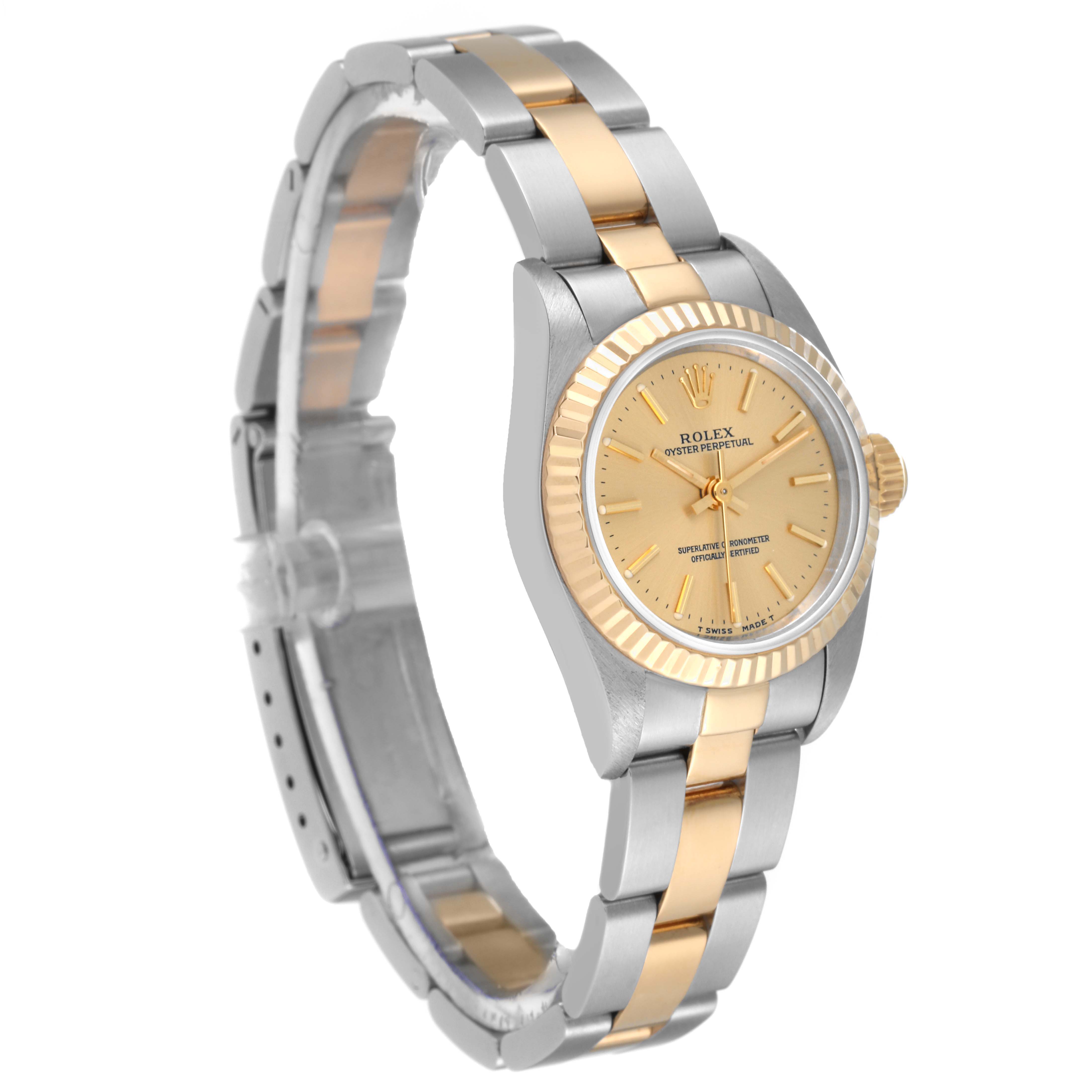 The Rolex Oyster Perpetual 67193 Women's Steel and Gold (two tone) Champagne Dial 67193 Women's Steel and Gold (two tone) Champagne Dial watch is shown at a slight angle, displaying its two-tone bracelet, fluted bezel, and champagne dial.