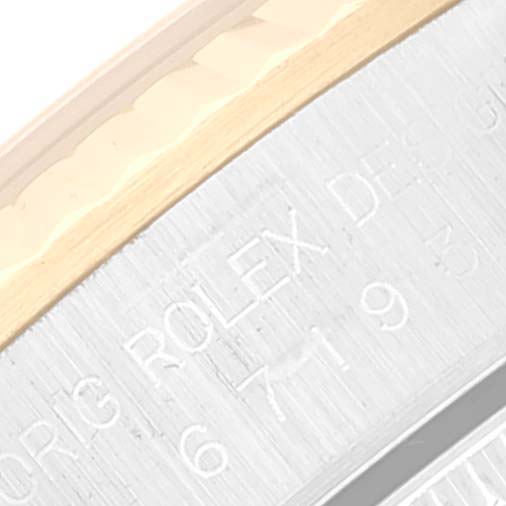 This image shows a close-up of the engraved side of a Rolex Oyster Perpetual 67193 Women's Steel and Gold (two tone) Champagne Dial 67193 Women's Steel and Gold (two tone) Champagne Dial model watch case.