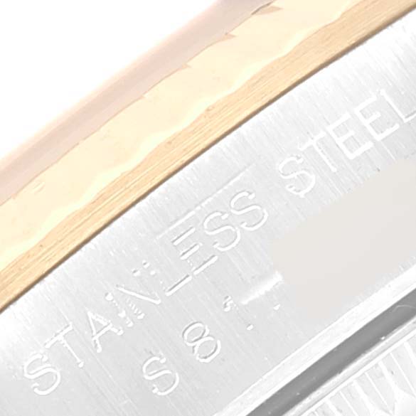 This image shows a close-up angle of the stainless steel engraved part on a Rolex Oyster Perpetual 67193 Women's Steel and Gold (two tone) Champagne Dial 67193 Women's Steel and Gold (two tone) Champagne Dial watch.