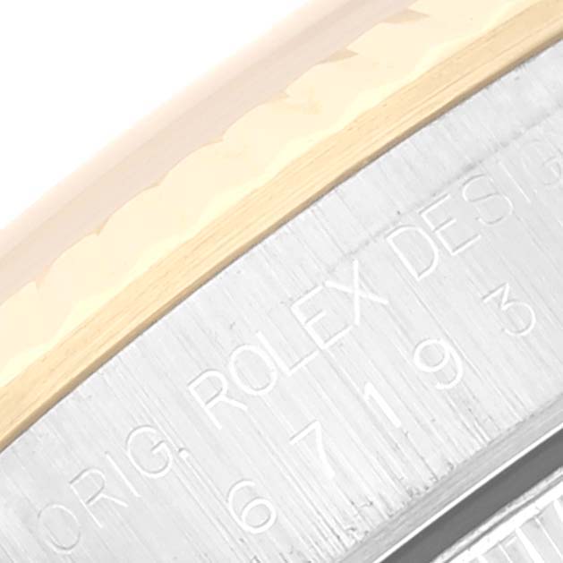 The image shows an angled close-up of the bezel and engraving on a Rolex Oyster Perpetual 67193 Women's Steel and Gold (two tone) Champagne Dial 67193 Women's Steel and Gold (two tone) Champagne Dial watch.