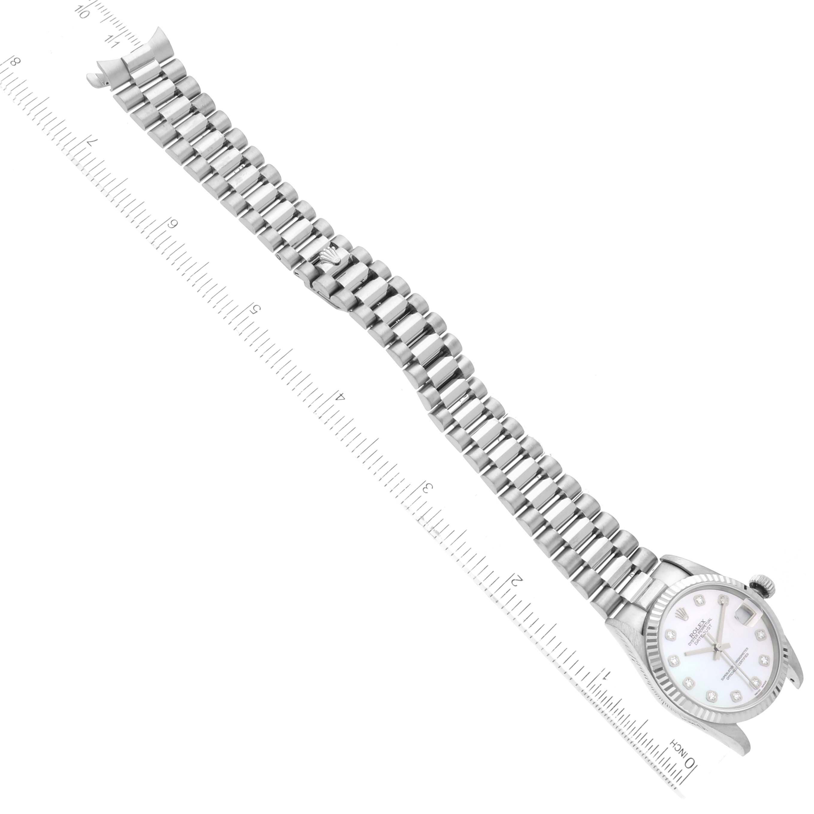 The image shows a Rolex President 68279 Women's White Gold Mother of Pearl Dial 68279 Women's White Gold Mother of Pearl Dial model watch laid flat, highlighting the face, bezel, and full-length bracelet with a ruler for scale.