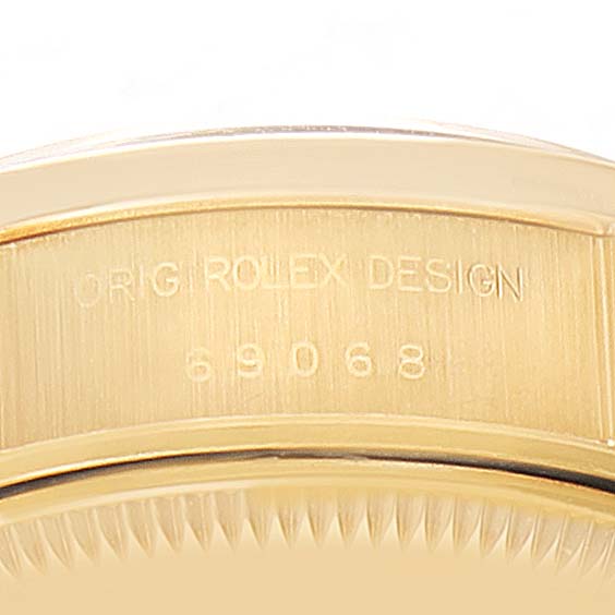 This image shows a close-up of the case-side of a Rolex President 69068 Women
s Yellow Gold Champagne Dial 69068 Women
s Yellow Gold Champagne Dial watch, displaying the serial number and "ORIG ROLEX DESIGN" imprint.