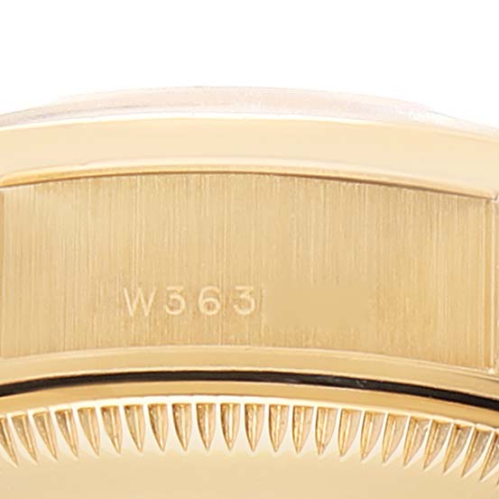 This image shows a close-up of the side and bezel of a Rolex President 69068 Women
s Yellow Gold Champagne Dial 69068 Women
s Yellow Gold Champagne Dial model watch with the number "W563" engraved.