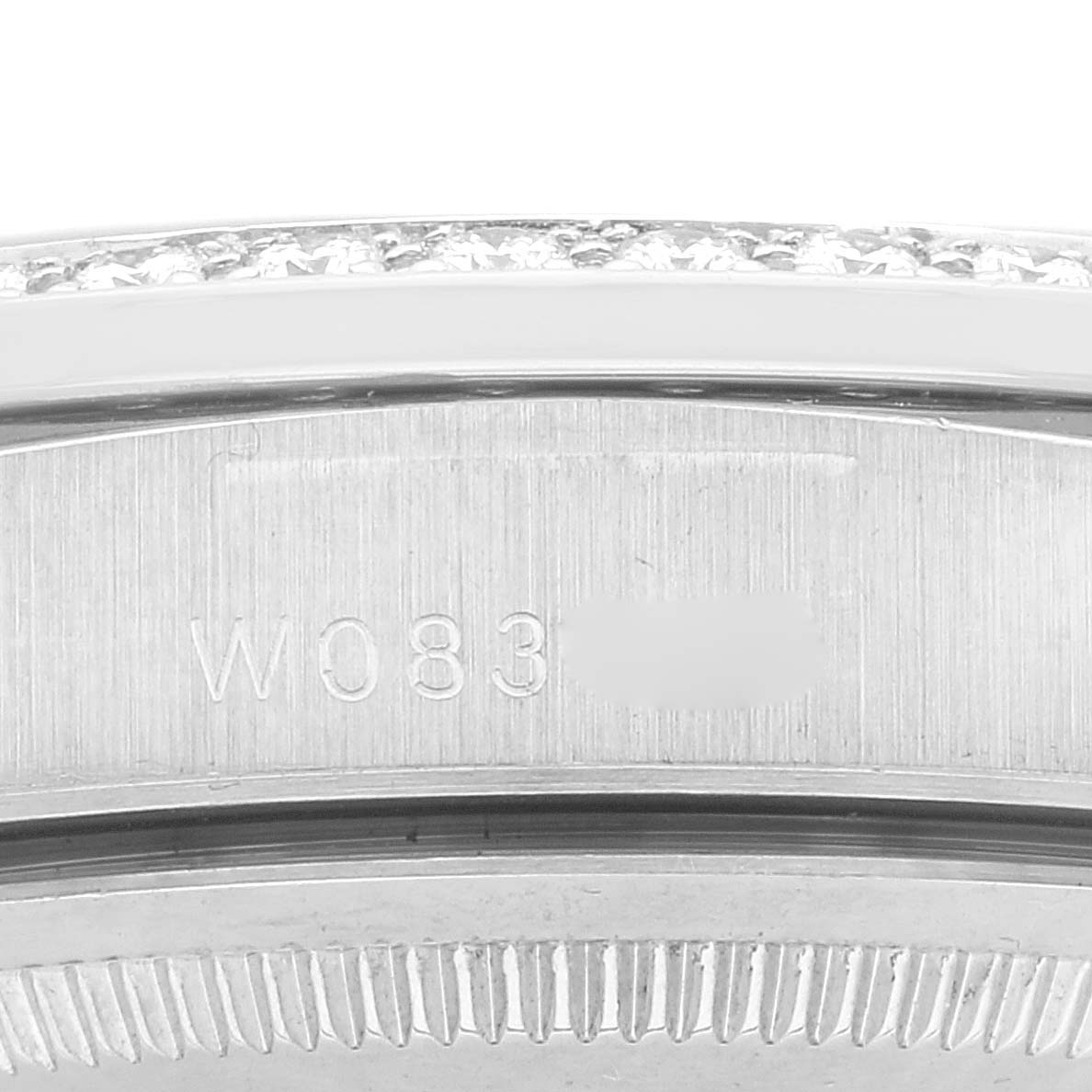 Close-up of the side view of a Rolex President 18389 Men's White Gold Silver Dial 18389 Men's White Gold Silver Dial watch, showing the bezel with embedded diamonds and part of the case.