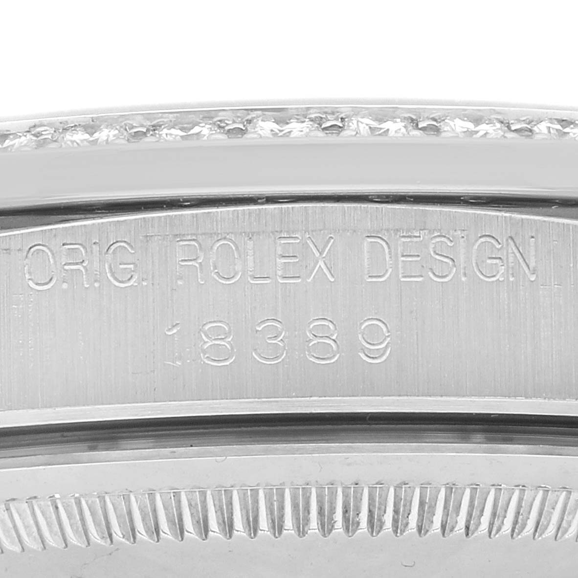 The image shows a close-up of the engraved rehaut of a Rolex President 18389 Men's White Gold Silver Dial 18389 Men's White Gold Silver Dial model watch.