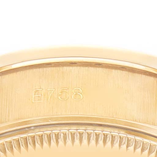 The image shows the side view of the case of a Rolex President 69158 Women
s Yellow Gold Grey Dial 69158 Women
s Yellow Gold Grey Dial model watch, highlighting the serial number and part of the bezel.