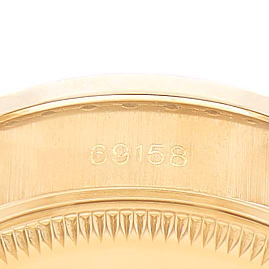 This is a close-up of the side of a Rolex President 69158 Women
s Yellow Gold Grey Dial 69158 Women
s Yellow Gold Grey Dial model watch, showing the model number 69158 and part of the bezel.