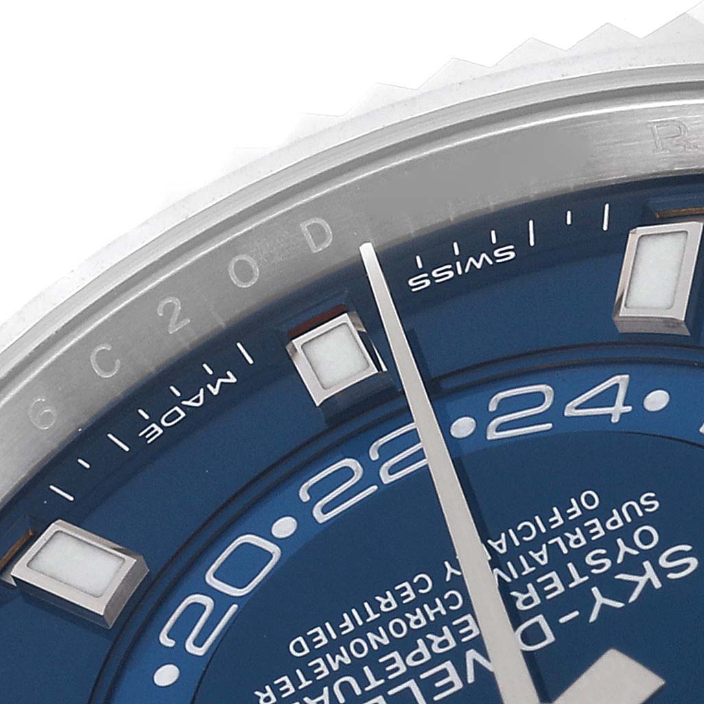 This close-up of a Rolex Sky-Dweller 326934 Men
s Stainless Steel Blue Dial 326934 Men
s Stainless Steel Blue Dial watch shows a partial view of the blue dial, hour markers, and minute hand.