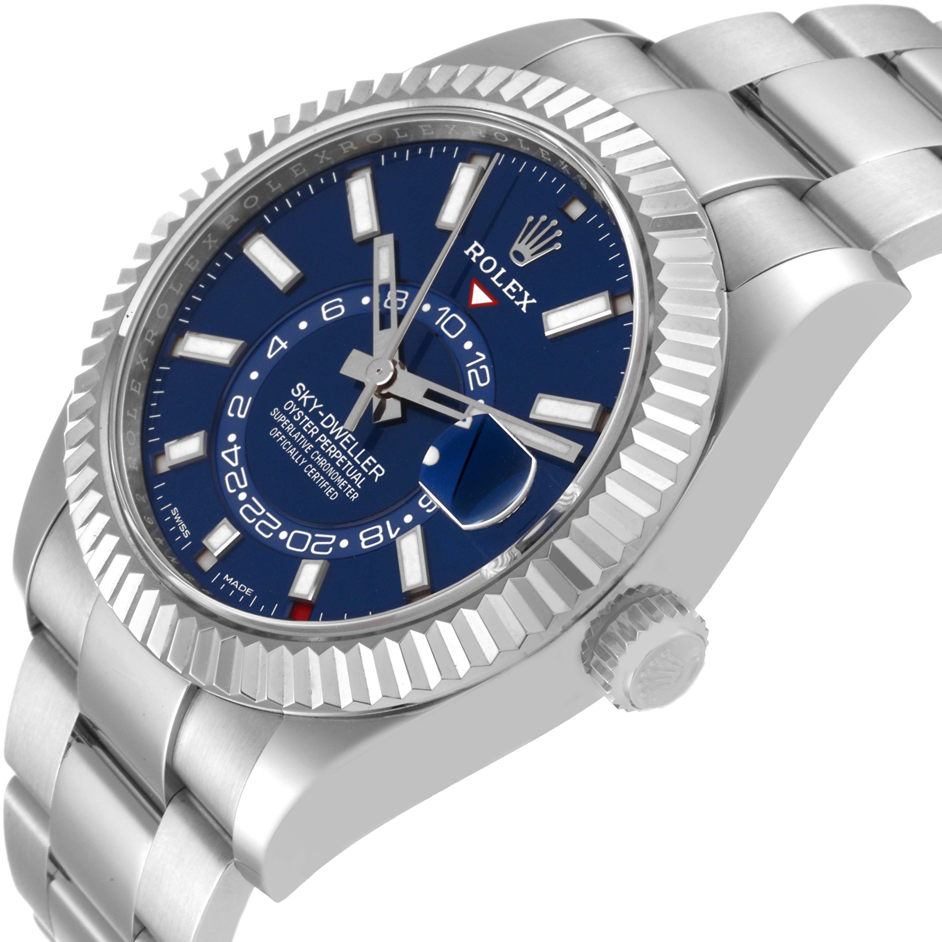 The Rolex Sky-Dweller 326934 Men's Stainless Steel Blue Dial 326934 Men's Stainless Steel Blue Dial watch is shown from a front angle, displaying its blue dial, fluted bezel, and part of the bracelet.
