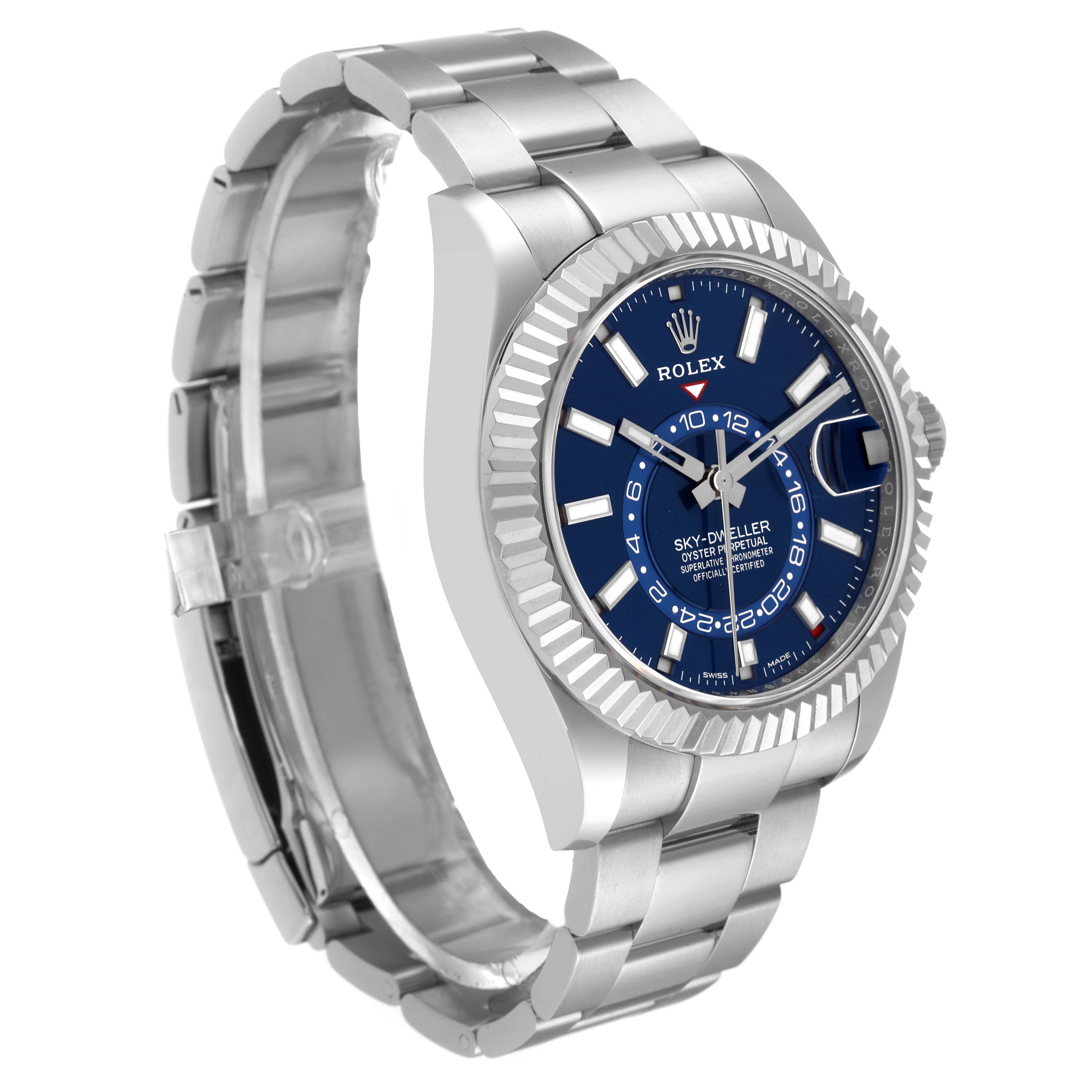 The image shows a side-front angle view of a Rolex Sky-Dweller 326934 Men's Stainless Steel Blue Dial 326934 Men's Stainless Steel Blue Dial watch, highlighting its blue dial, fluted bezel, and metal bracelet.