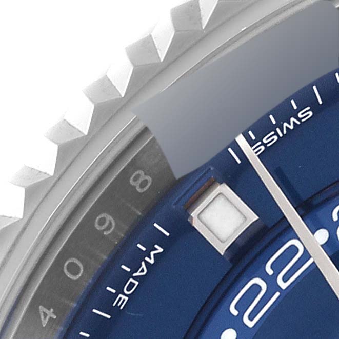 The image shows a close-up of the bezel and part of the dial of the Rolex Sky-Dweller 326934 Men's Stainless Steel Blue Dial 326934 Men's Stainless Steel Blue Dial watch.