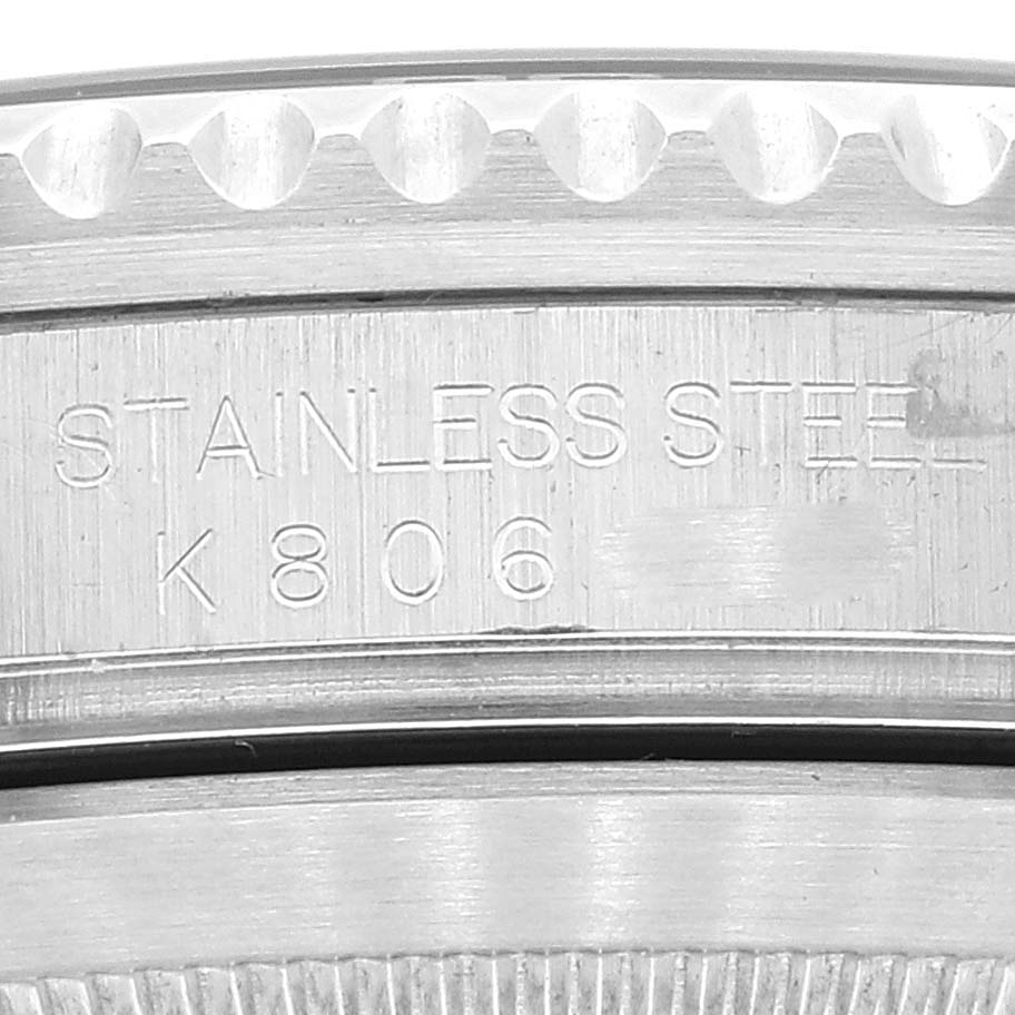 Close-up of the stainless steel case side for a Rolex Submariner 16610 Men's Stainless Steel Black Dial 16610 Men's Stainless Steel Black Dial model, showing the "STAINLESS STEEL" and serial number "K806."