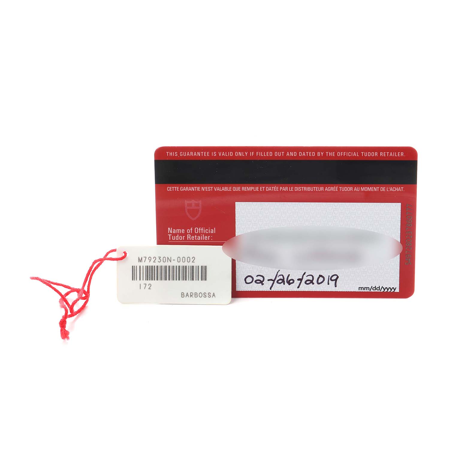 The image shows a warranty card and tag for a Tudor Heritage Black Bay M79230N-0002 Men
s Stainless Steel Black Dial M79230N-0002 Men
s Stainless Steel Black Dial, featuring model information and a date.