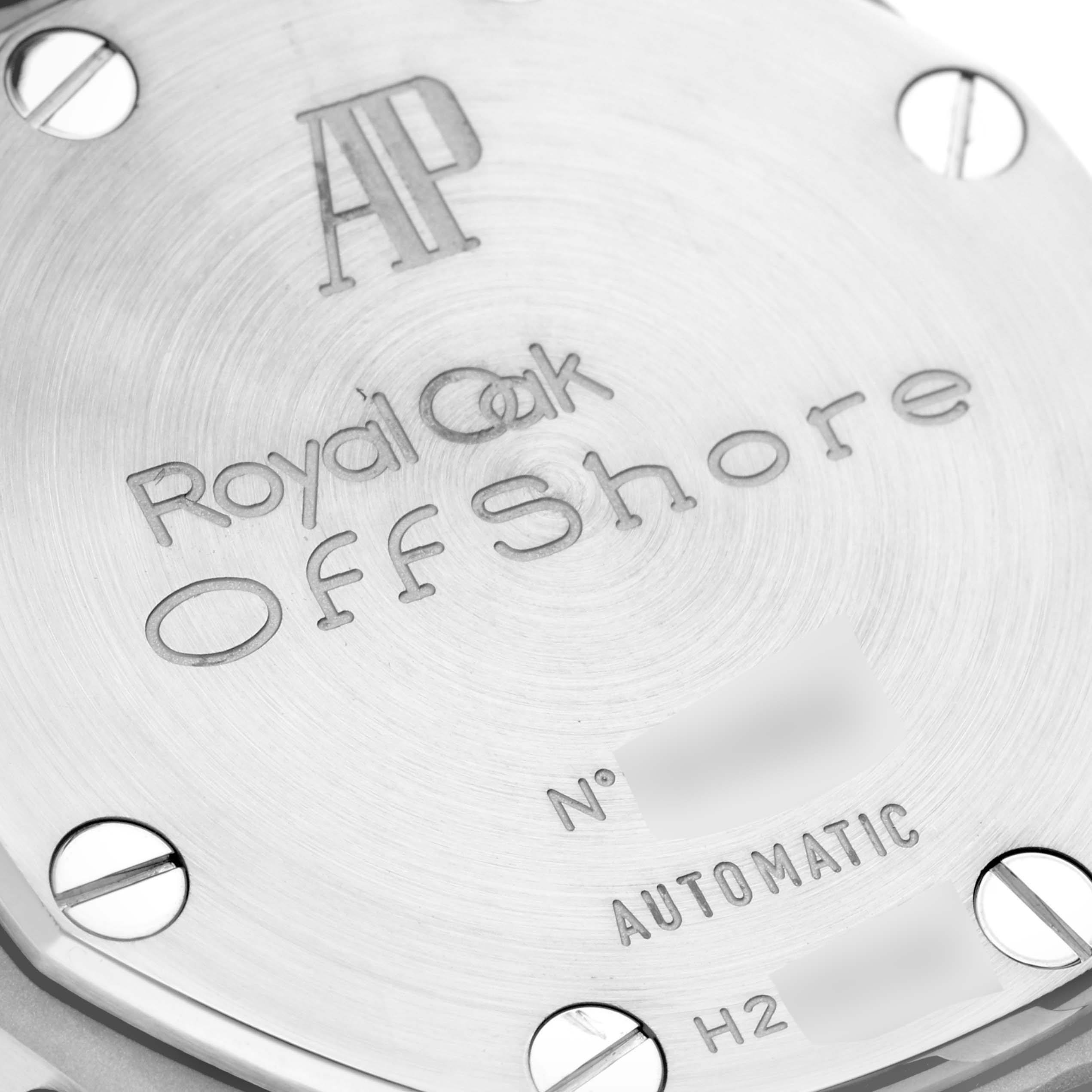 Close-up of the back of an Audemars Piguet Royal Oak Offshore 26170ST.OO.D101CR.03 Men's Stainless Steel Black Dial 26170ST.OO.D101CR.03 Men's Stainless Steel Black Dial watch showing the engraved model name and brand logo with visible screws.